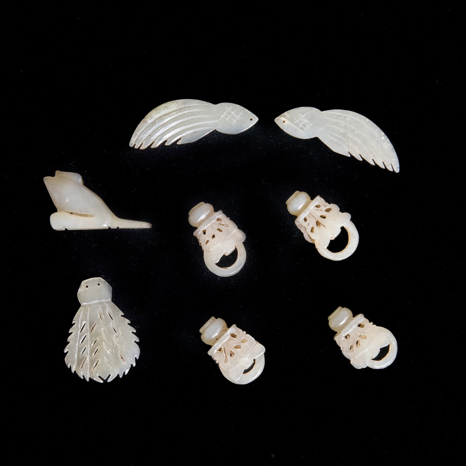(LOT OF 8) A GROUP OF EIGHT WHITE JADE ORNAMENTS: (lot of 8) A group of eight white jade ornaments. Largest: 5 x 1 cm
