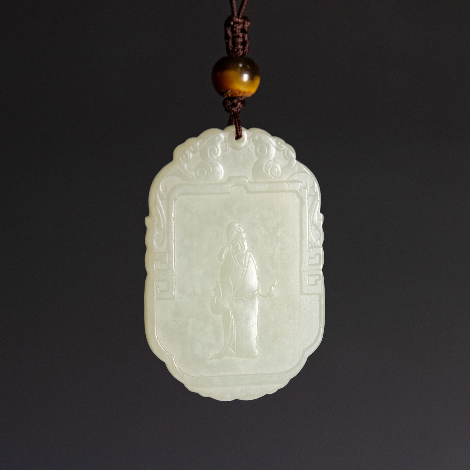 A CHINESE WHITE JADE PLAQUE: A Chinese white jade plaque. 1.97"h x 1.26"w x 0.2"l (5 x 3.2 x 0.5 cm) Provenance: Property from a San Francisco private collection.
