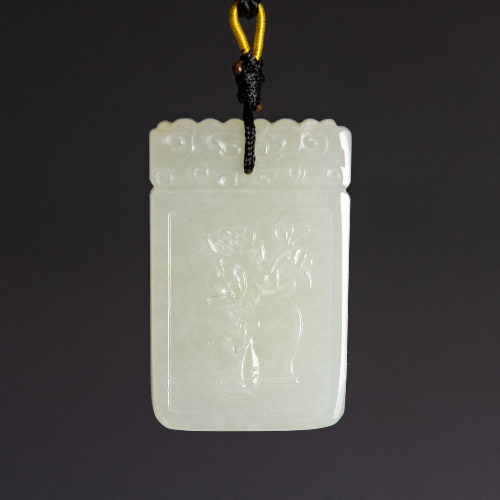 A CHINESE WHITE JADE PLAQUE: A Chinese white jade plaque. 1.85"h x 1.18"w x 0.28"l (4.7 x 3 x 0.7 cm) Provenance: Property from a San Francisco private collection.