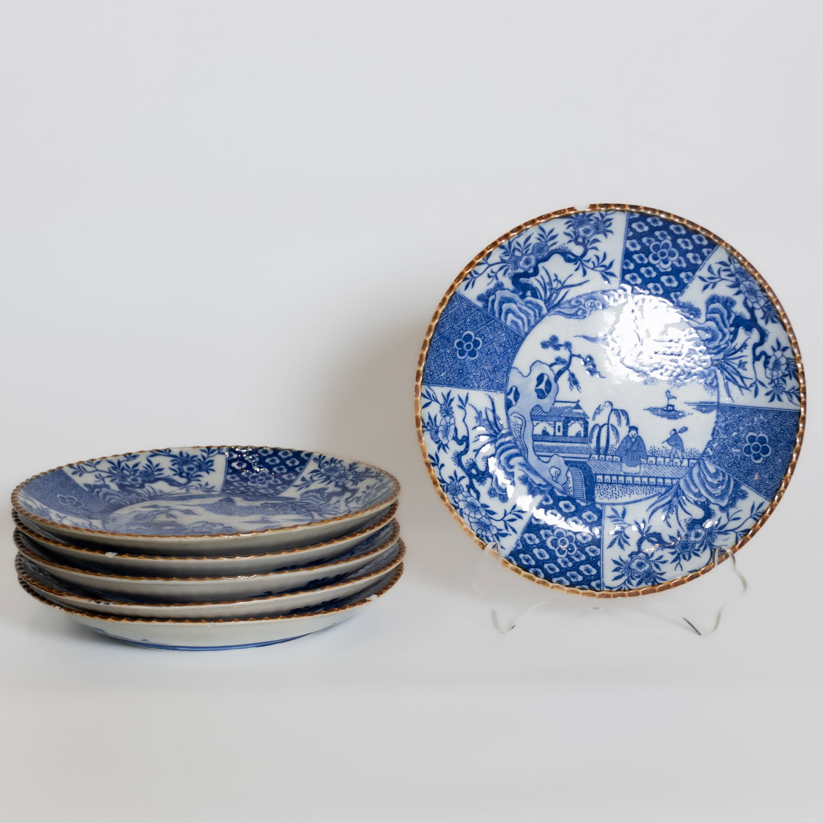 (LOT OF 6) A GROUP OF JAPANESE BLUE-AND-WHITE DISHES: (lot of 6) A group of Japanese blue-and-white dishes, five with marks and one without. Each: 24.5 x 3.5 cm Provenance: Private collection of the Smith family, Santa Monica, California, by descent.