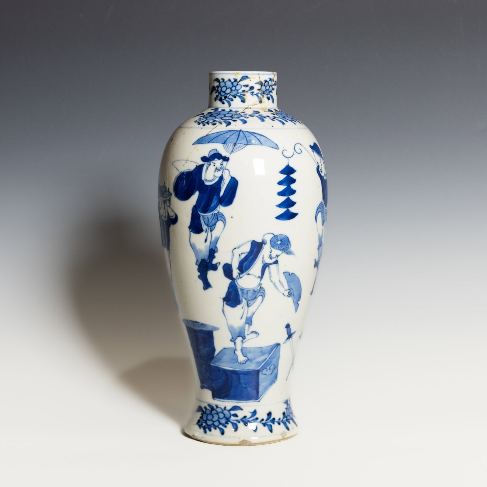 A CHINESE BLUE-AND-WHITE PORCELAIN FIGURAL VASE: A Chinese blue-and-white porcelain vase of baluster form, finely painted in underglaze cobalt with three standing scholars or attendants in a garden setting. The waisted neck and flared foot are decor
