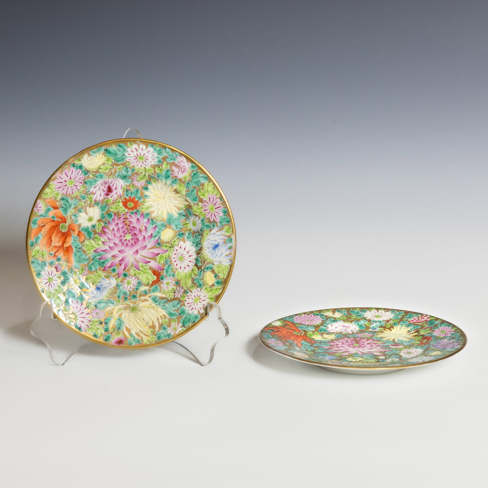 (LOT OF 2) A PAIR OF CHINESE FAMILLE-ROSE MILLEFLEURS PORCELAIN PLATES: (lot of 2) A pair of Chinese famille-rose porcelain plates decorated in the traditional millefleurs ("hundred flowers") pattern. Each plate features a large blooming chrysanthemum at the center surrou