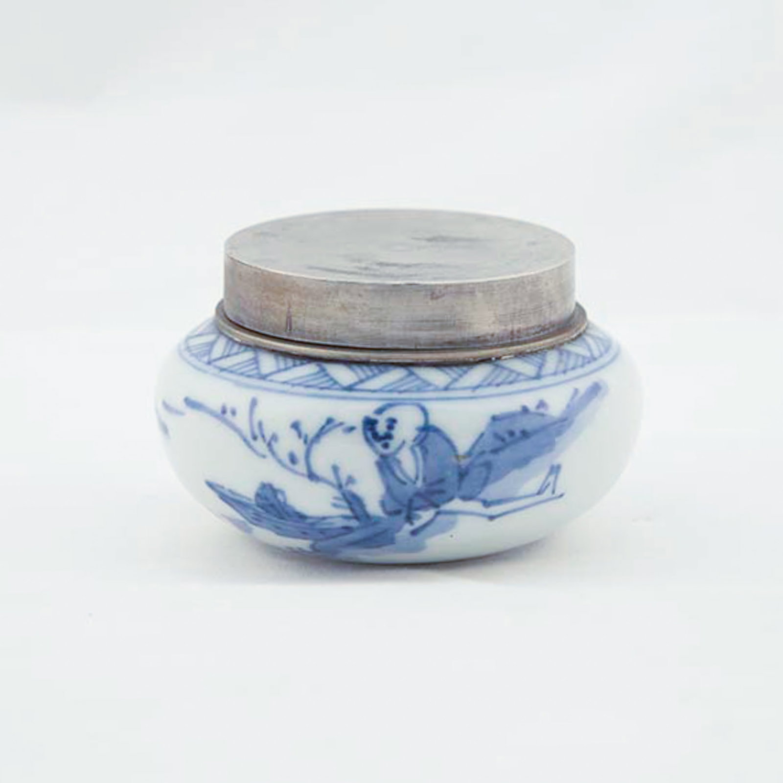 A SMALL CHINESE BLUE-AND-WHITE JAR WITH METAL COVER: A small Chinese blue-and-white jar painted with a figure in a landscape, with an underglaze seal mark on the base, and mounted with a metal base and cover. 5 x 8 cm Provenance: From an estate in
