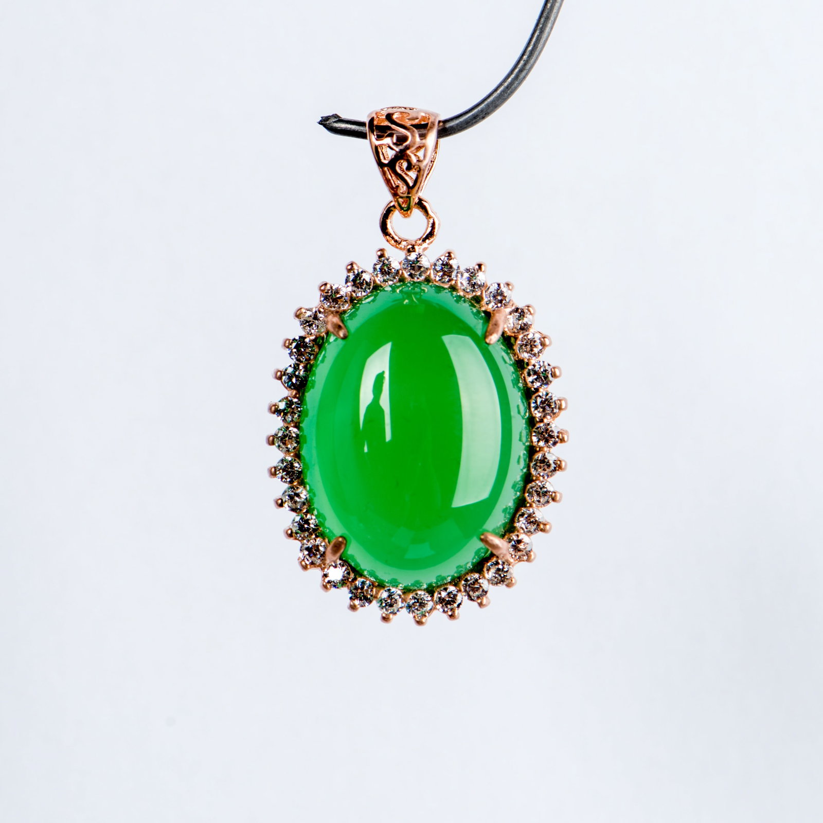 A JADEITE AND DIAMOND PENDANT: A jadeite and diamond pendant. 0.75"h x 0.6"w (1.91 x 1.52 cm)