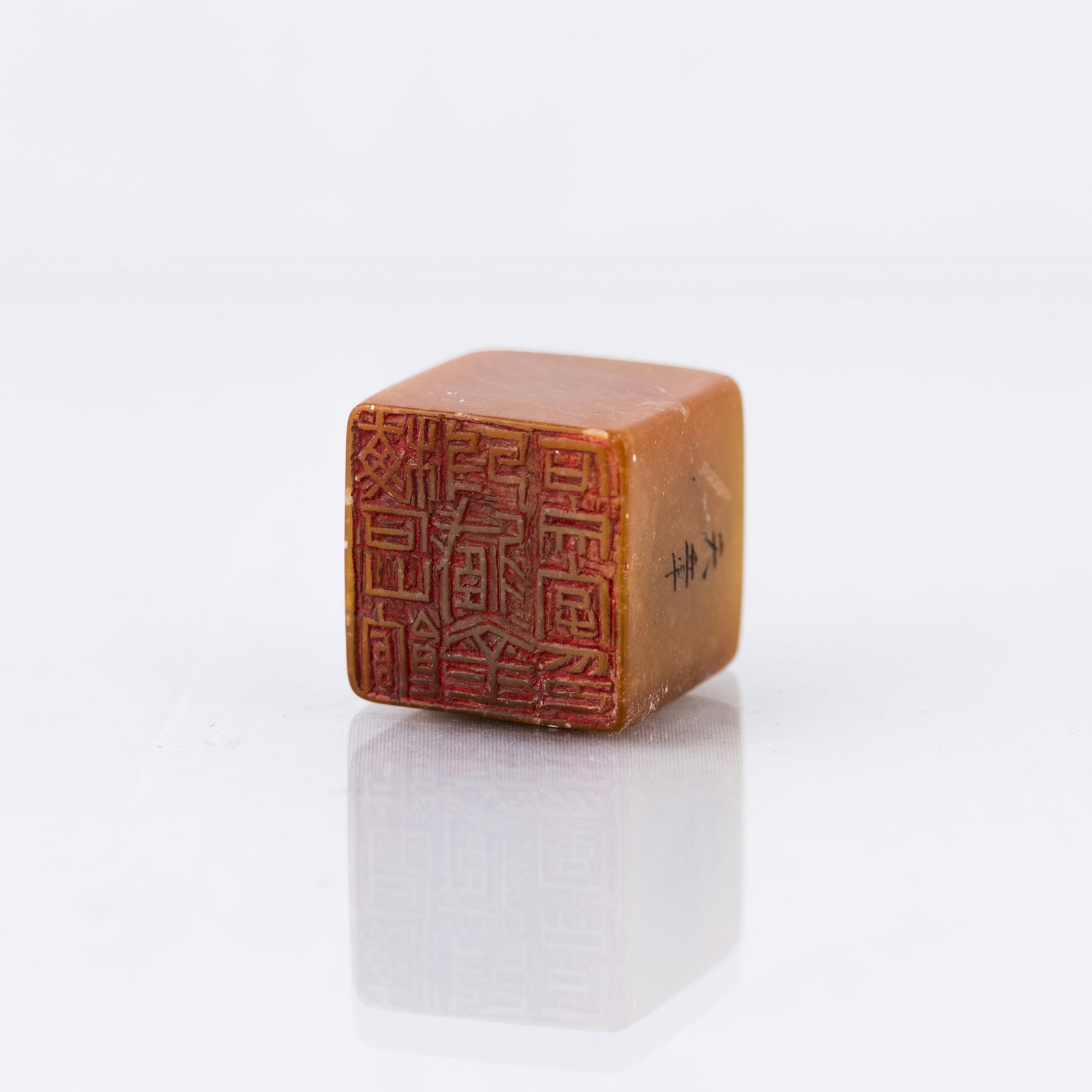 SOAPSTONE SEAL: Yellow soapstone seal, finely carved with a cloud motif on top. 1.18"h x 1.18"w x 1.18"l (3 x 3 x 3 cm)