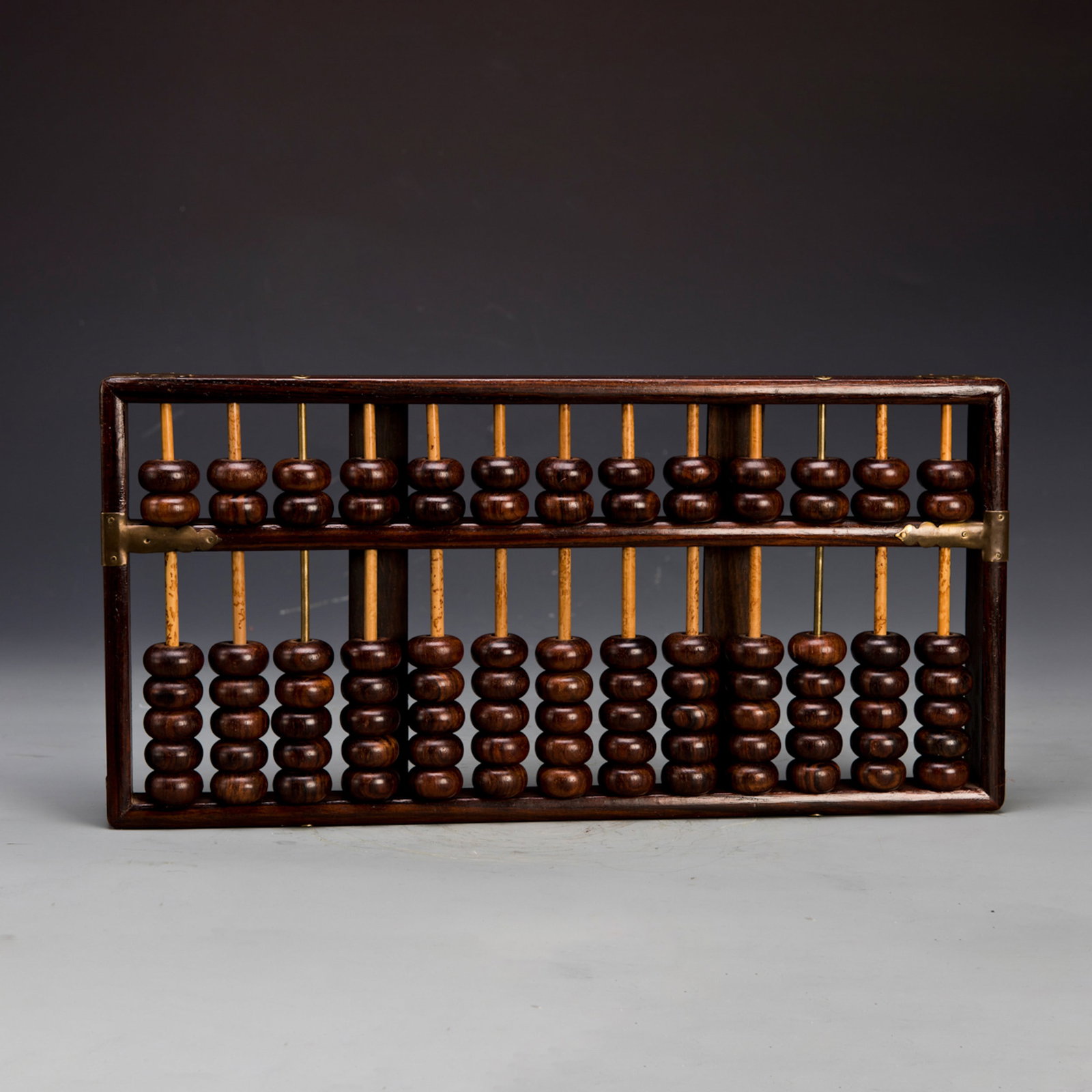 A WOOD ABACUS: A wood abacus of classic form. 14.5"l x 7"w x 1"h Condition: Normal wear and tear.