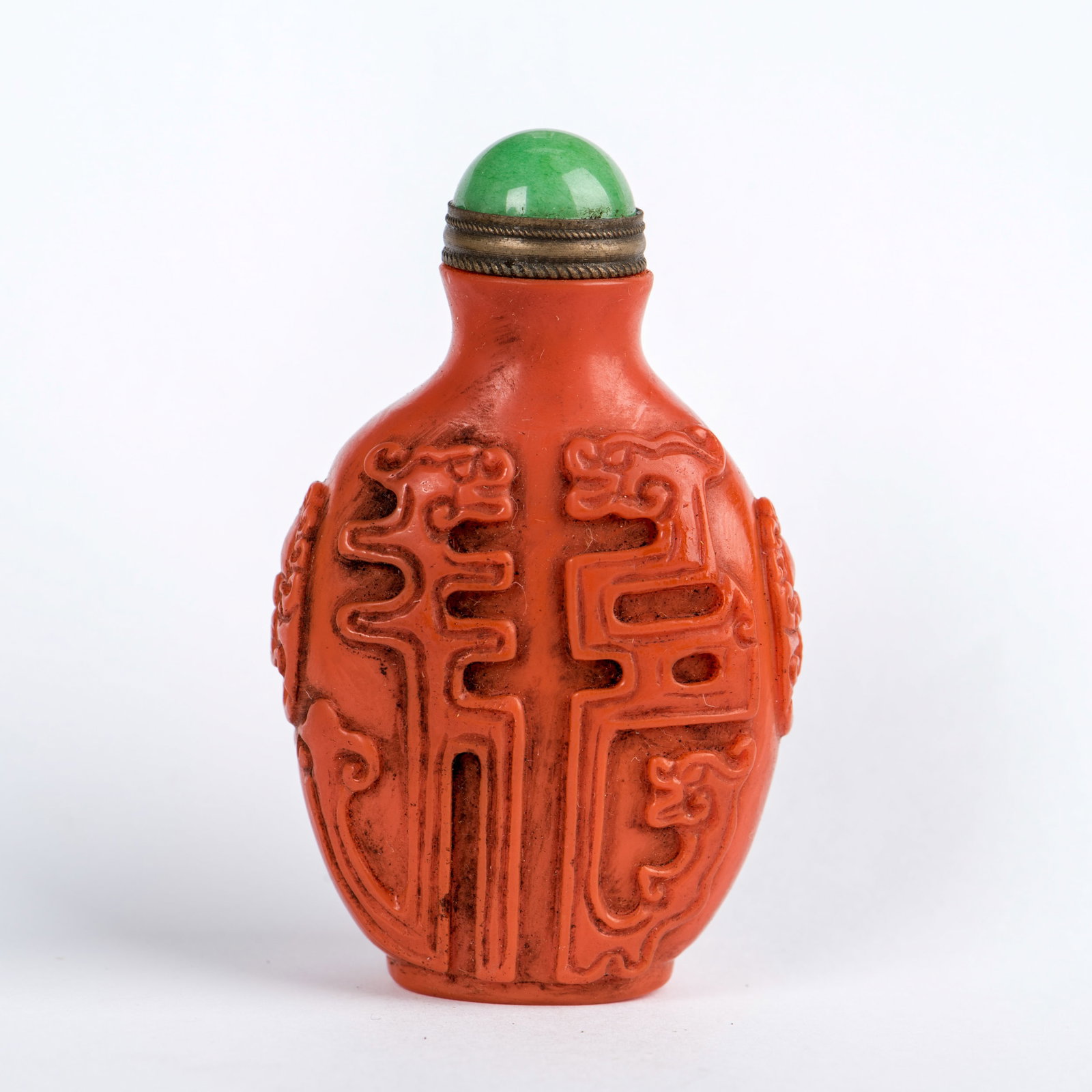 AN IRON-RED PORCELAIN SNUFF BOTTLE: An iron-red porcelain snuff bottle. 2.95"h x 1.77"w (7.5 x 4.5 cm)