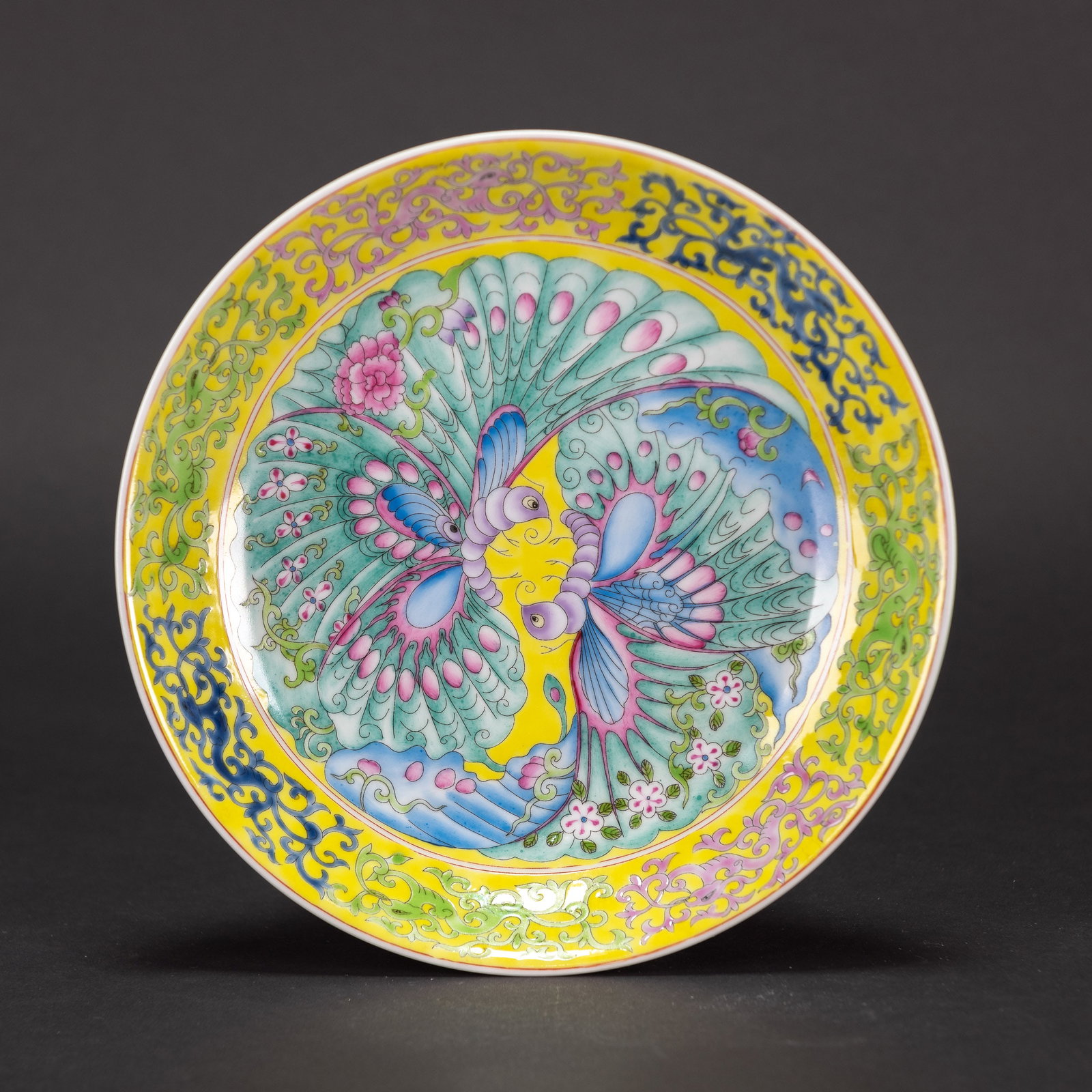 A YELLOW-GROUND FAMILLE-ROSE 'BUTTERFLY' DISH, YONGZHENG MARK: A yellow-ground famille-rose 'butterfly' dish, Yongzheng mark. 21 x 4.5 cm
