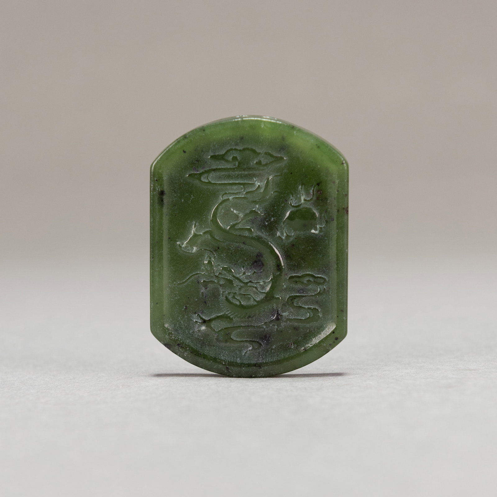 CHINESE SPINACH JADE 'DRAGON' PLAQUE: Chinese spinach jade 'dragon' plaque. 2.17"h x 1.57"w x 0.16"l (5.5 x 4 x 0.4 cm)