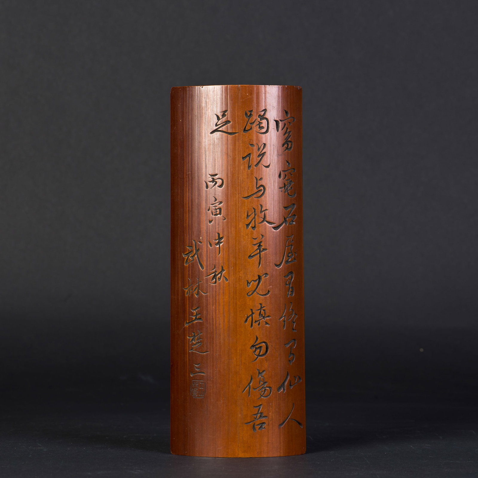 A BAMBOO-CARVED ARMREST WITH CALLIGRAPHY: A bamboo-carved armrest with carved calligraphy, signed with a seal. 9.75"h x 3.5"w