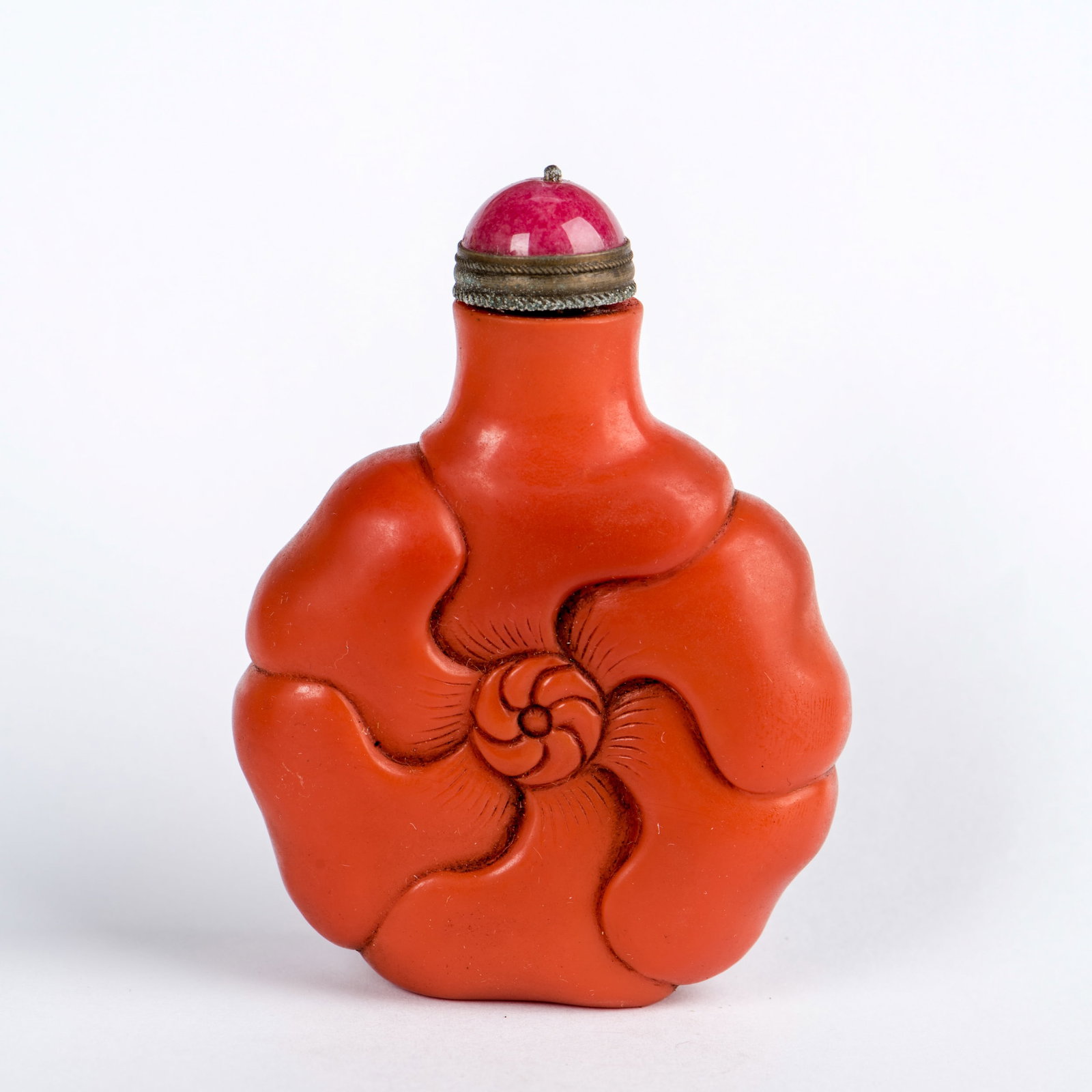 AN IRON-RED PORCELAIN SNUFF BOTTLE: An iron-red porcelain snuff bottle. 3.15"h x 2.36"w (8 x 6 cm)