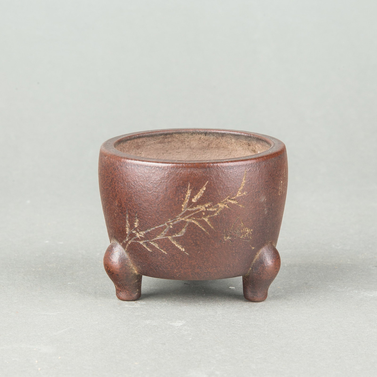 A SMALL ZISHA TRIPOD JARDINIERE: A small Zisha tripod jardiniere of rounded form, supported on three short feet and carved in low relief with bamboo. H6 x 7.5 cm
