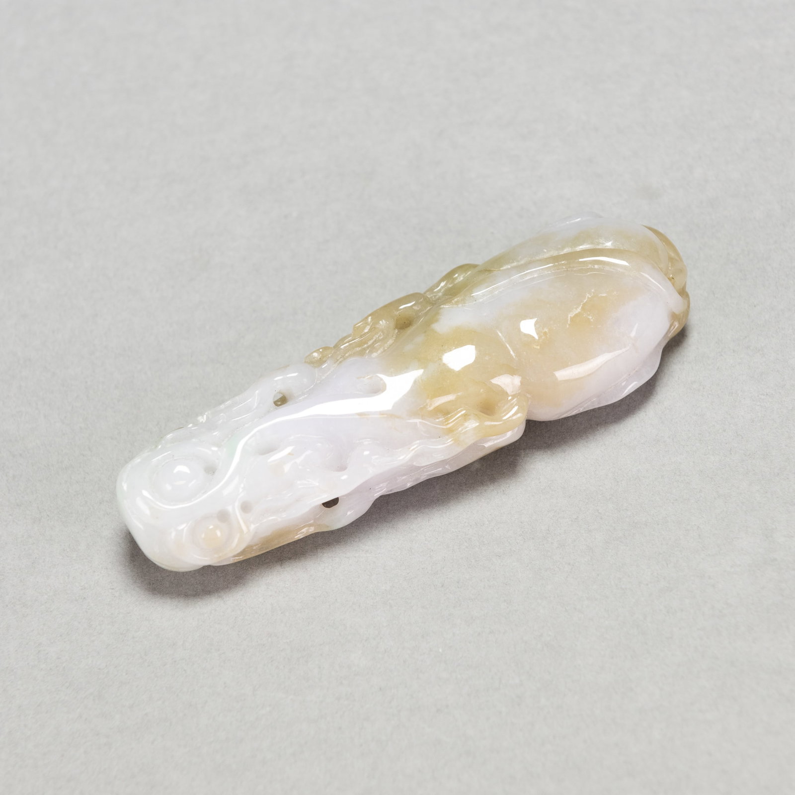 CARVED JADEITE PENDANT: Carved jadeite pendant. Approximately 3.94"h x 1.34"w x 0.59"l (10 x 3.4 x 1.5 cm); 65.4 dwt