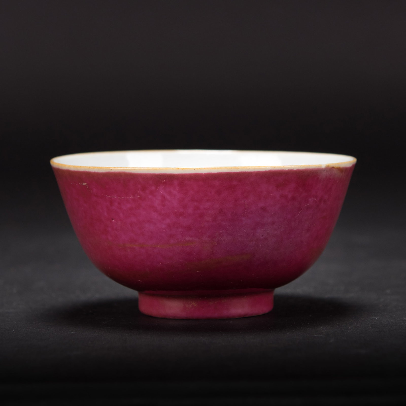 A CHINESE RUBY-GLAZED BOWL: A Chinese ruby-glazed bowl. 2.07"h x 4.04"d (5.25 x 10.25 cm)