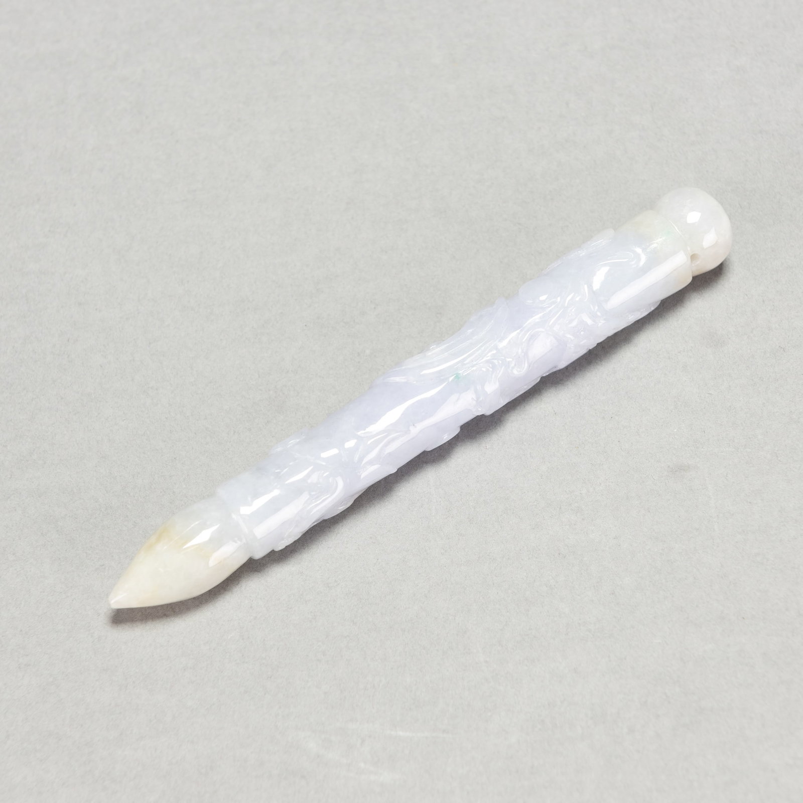 CHINESE LAVENDER JADEITE CARVING OF A BRUSH PEN: Chinese lavender jadeite carving of a brush pen. 4.92"l x 0.51"d (12.5 x 1.3 cm)