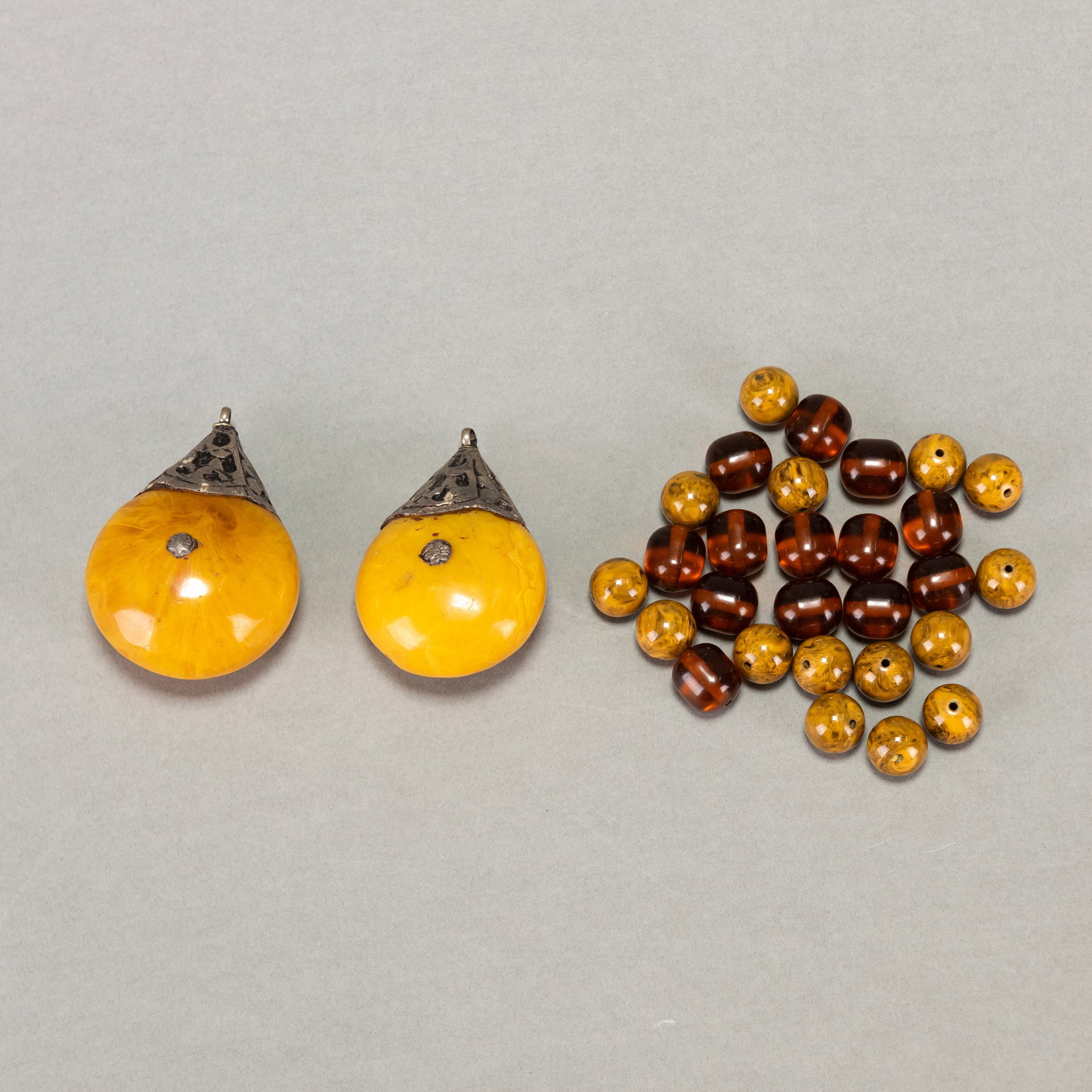 (LOT OF 30) TIBET-STYLE LARGE BEESWAX PENDANTS AND BEADS: (lot of 30) Tibet-style large beeswax pendants and 28 beads. Largest pendant: 2.95"h (7.5 cm) Beads: 0.51"d (1.3 cm)