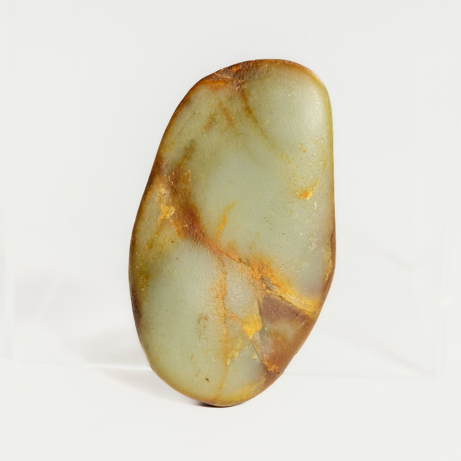 CHINESE RUSSET JADE PEBBLE: Chinese russet jade pebble. 4.53"h x 2.76"w x 1.18"d (11.5 x 7 x 3 cm)