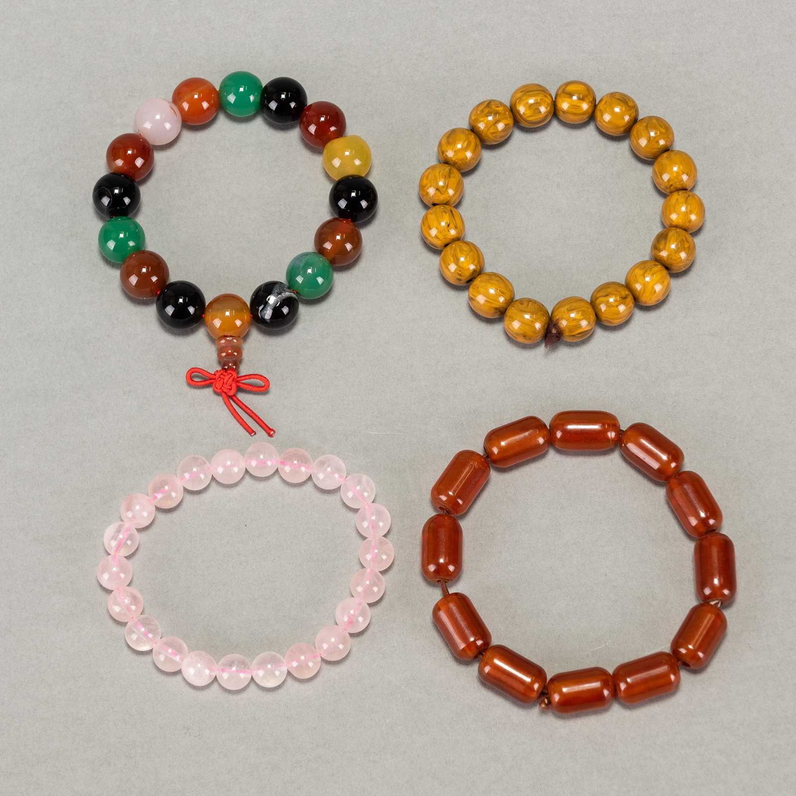 (LOT OF 4) AGATE, ROSE QUARTZ AND BEESWAX RESIN BEAD BRACELETS: (lot of 4) Agate, rose quartz and beeswax resin bead bracelets. Approx. length: 7.87" (20 cm)