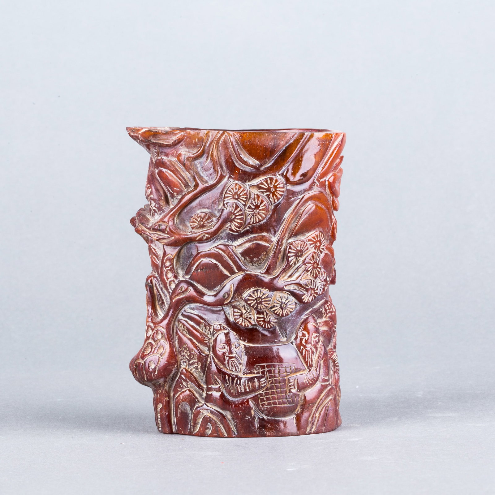 A CARVED BRUSH POT: A carved brush pot, carved around the exterior with figures. H11.5 x 8 cm