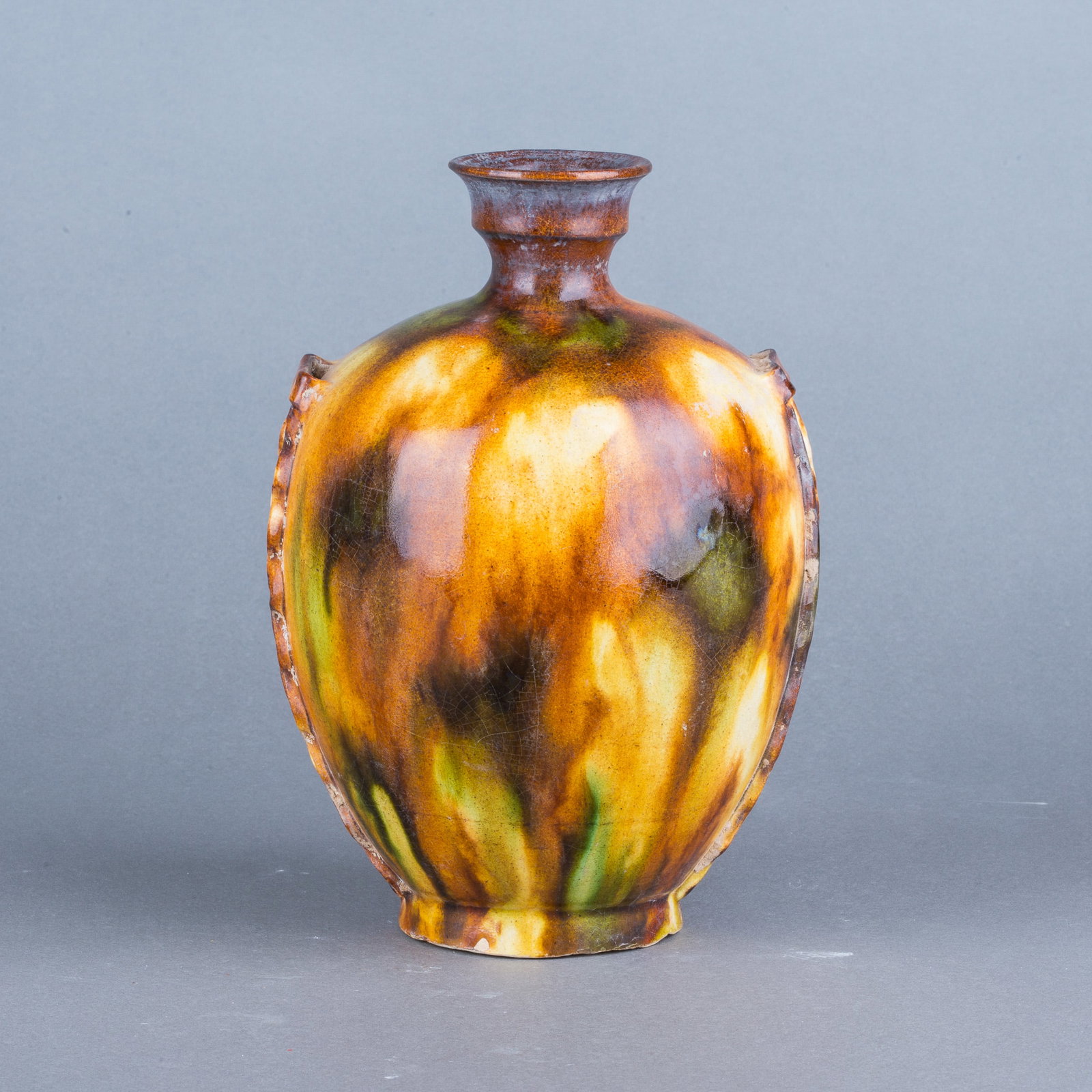 A CHINESE SANCAI VASE: A Chinese sancai vase of rounded form, covered overall with green, brown and yellow glazes. H19 x 12 cm