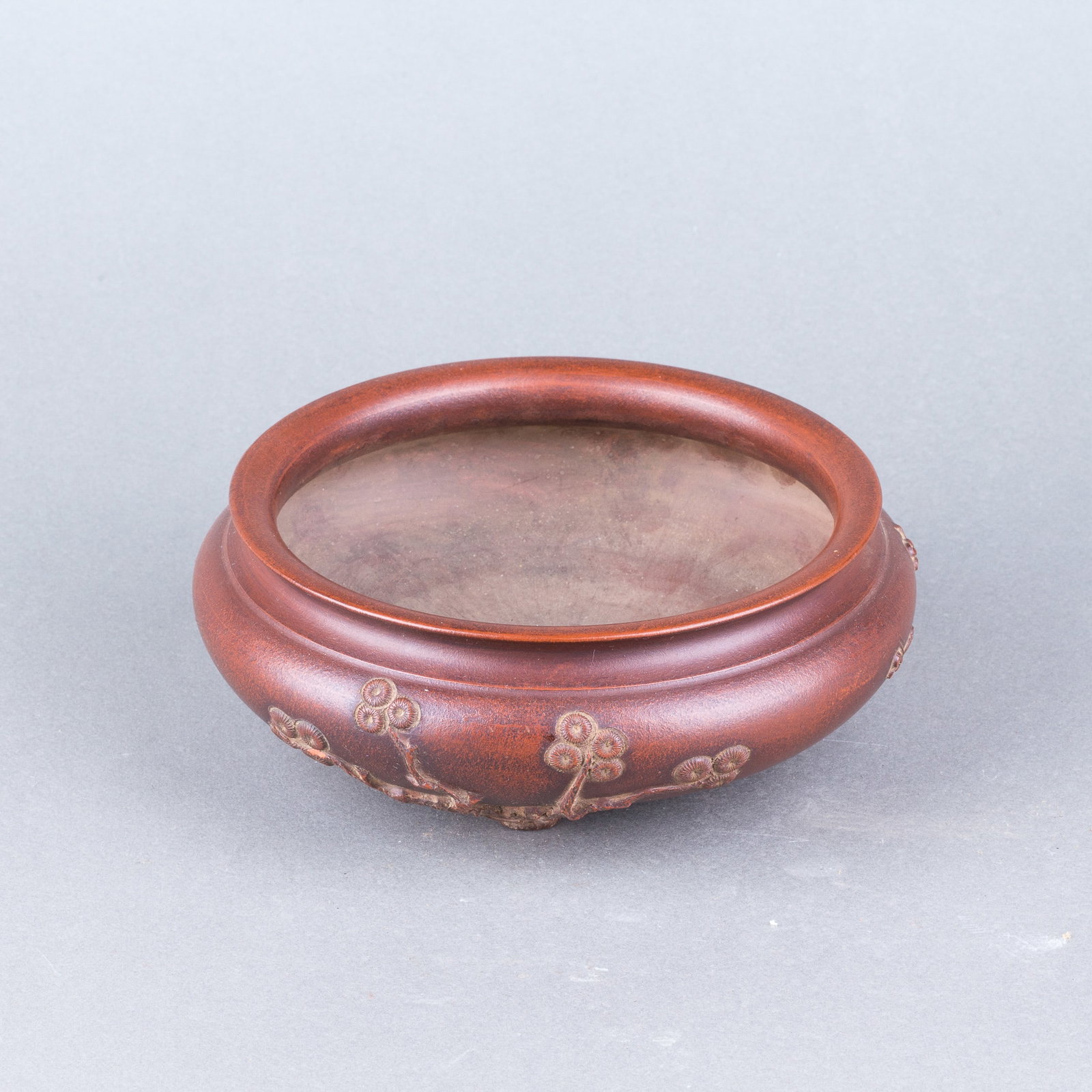 A ZISHA TRIPOD CENSER: A Zisha tripod censer of compressed rounded form, decorated with plum blossoms. H6.5 x 16 cm