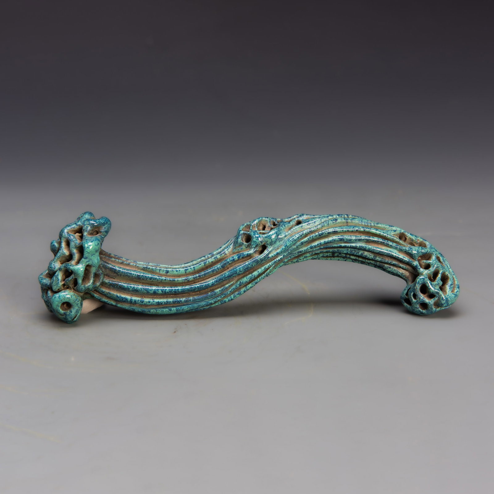 TURQUOISE-BLUE-GLAZED PORCELAIN LINGZHI: Porcelain lingzhi covered in a turquoise-blue glaze. 1.25"h x 2.5"w x 8.5"l (3.18 x 6.35 x 21.59 cm)