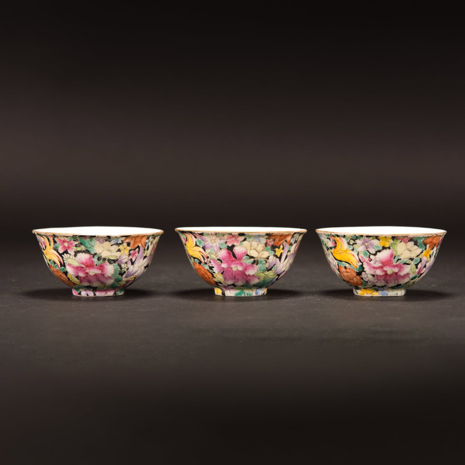 (LOT OF 3) GROUP OF FAMILLE-NOIRE BOWLS, QIANLONG MARK: (lot of 3) Group of famille-noire bowls, Qianlong mark. Each has deep rounded sides decorated with various blossoming flowers on a black enamel ground. H4.5 x 9.25 cm
