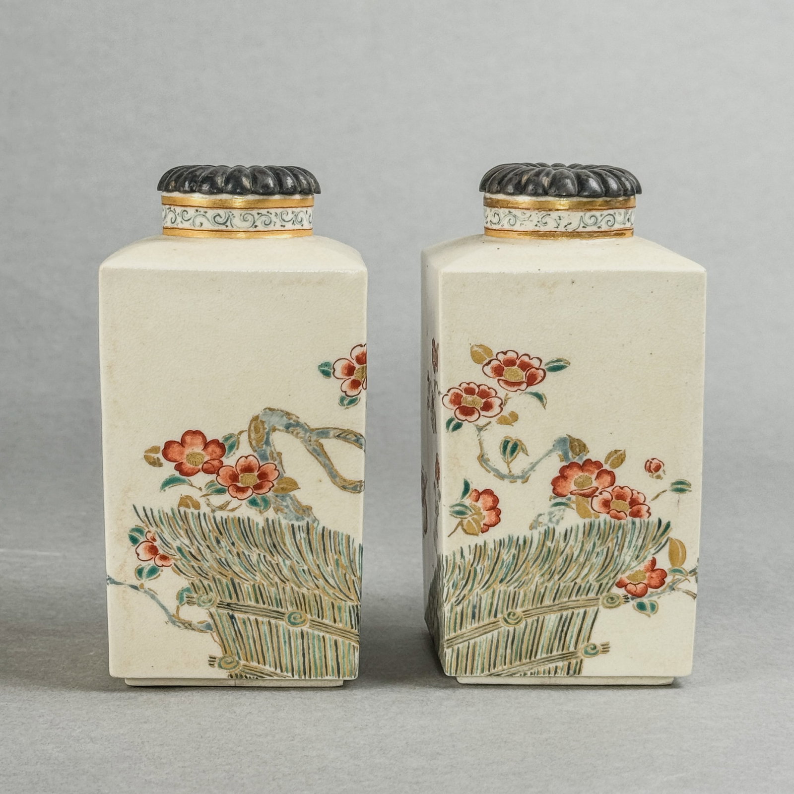 PAIR OF JAPANESE SATSUMA VASES WITH STERLING SILVER CHRYSANTHEMUM LIDS: A pair of Japanese Satsuma vases with sterling silver chrysanthemum lids. Dimensions: Height: 5 in. (12.7 cm). Note: This item is in New York, where it can be shipped from.