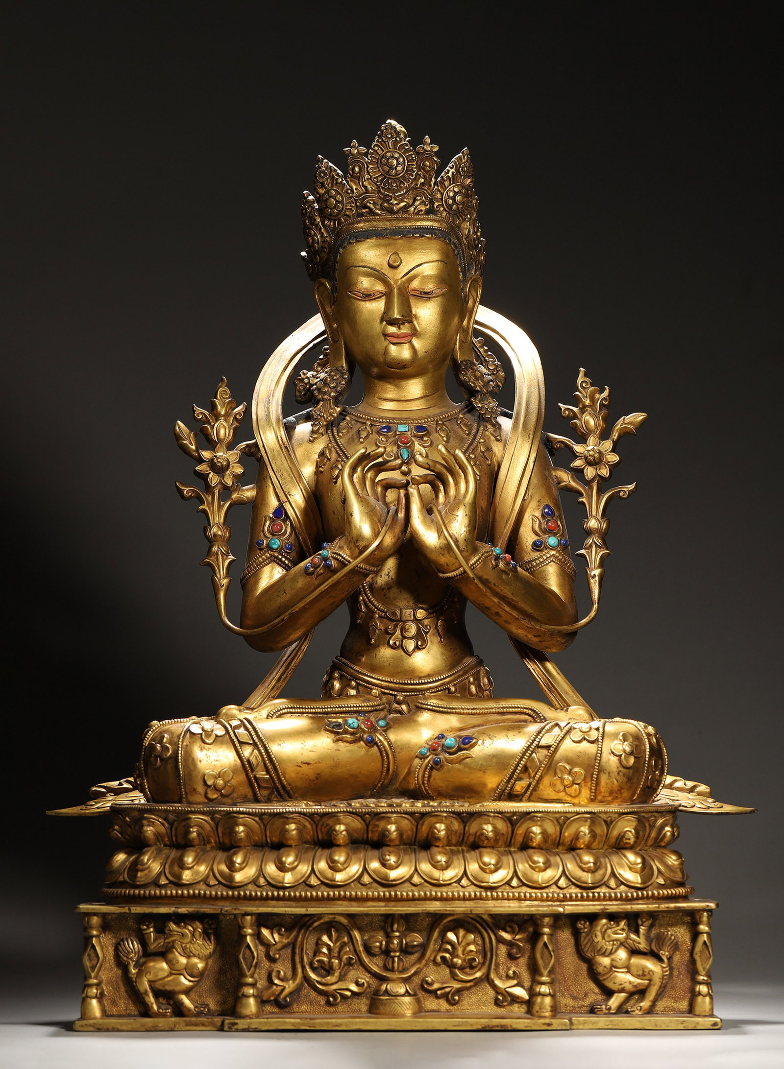 A GILT-BRONZE MAHAVAIROCANA FIGURE: A gilt-bronze figure of Mahavairocana seated on a lotus base. L. 37 cm; Ht. 54 cm.