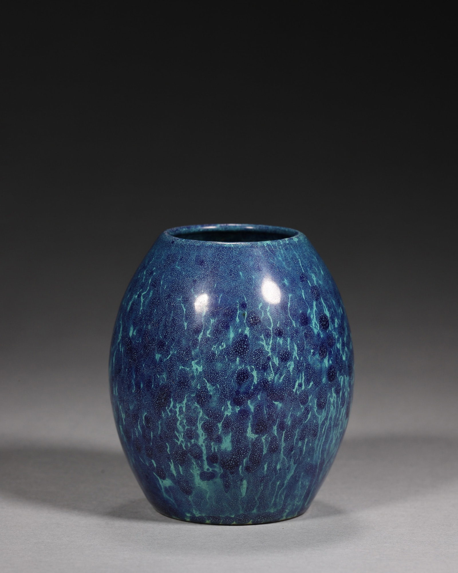 A ROBIN'S-EGG-GLAZED OLIVE-FORM WATER POT: A porcelain water pot of olive form, covered overall in a mottled robin's-egg glaze in blue and green tones. The base bears a carved mark reading 'Qianlong'. W. 6.5 cm; Ht. 8.4 cm.