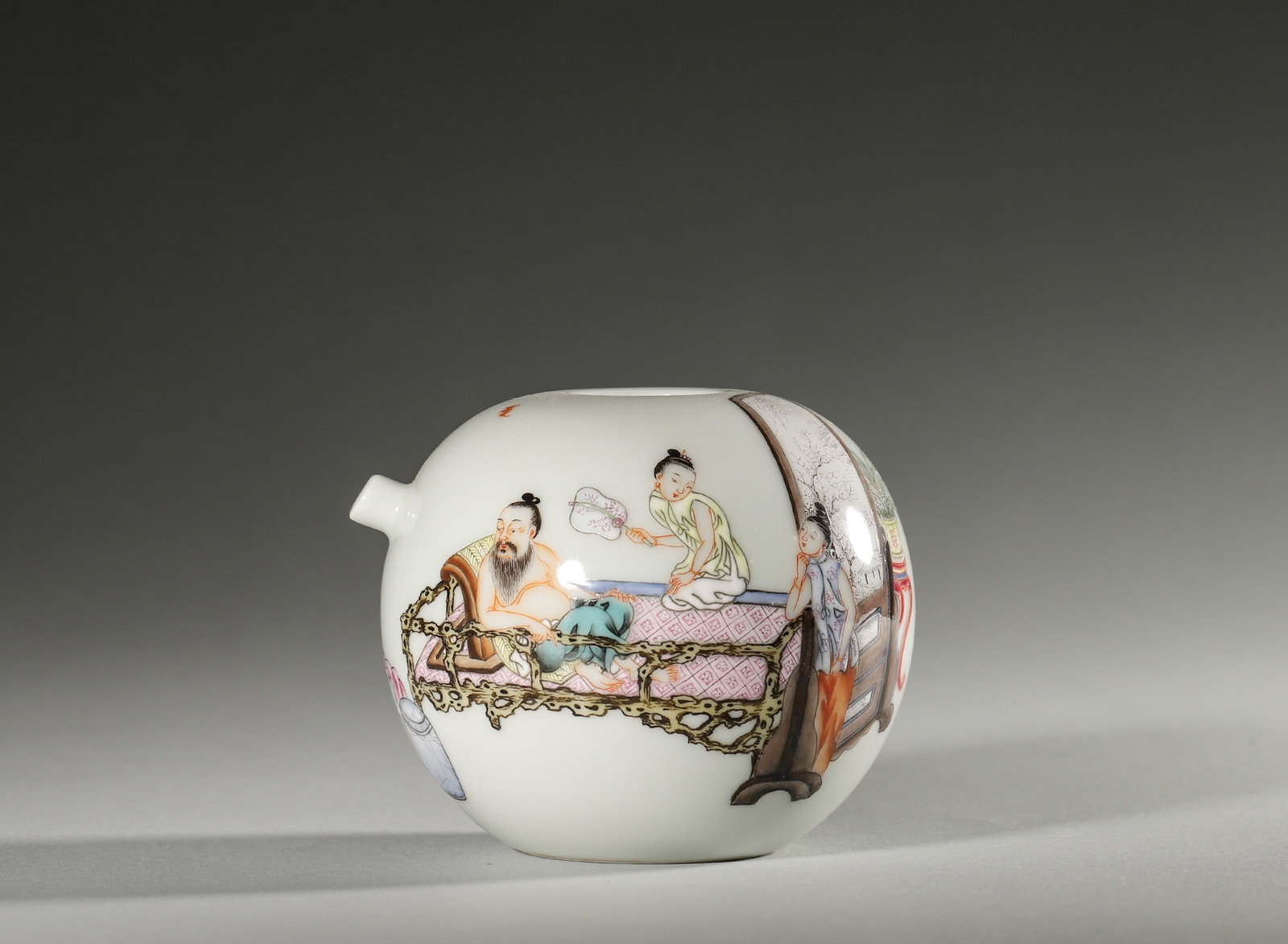 A FAMILLE-ROSE FIGURAL WATER DROPPER: A spherical famille-rose porcelain water dropper with a spout, painted with a figural scene of an adult and children. The base bears a mark reading 'Yongzheng'. Diam. 9 cm; Ht. 7 cm.