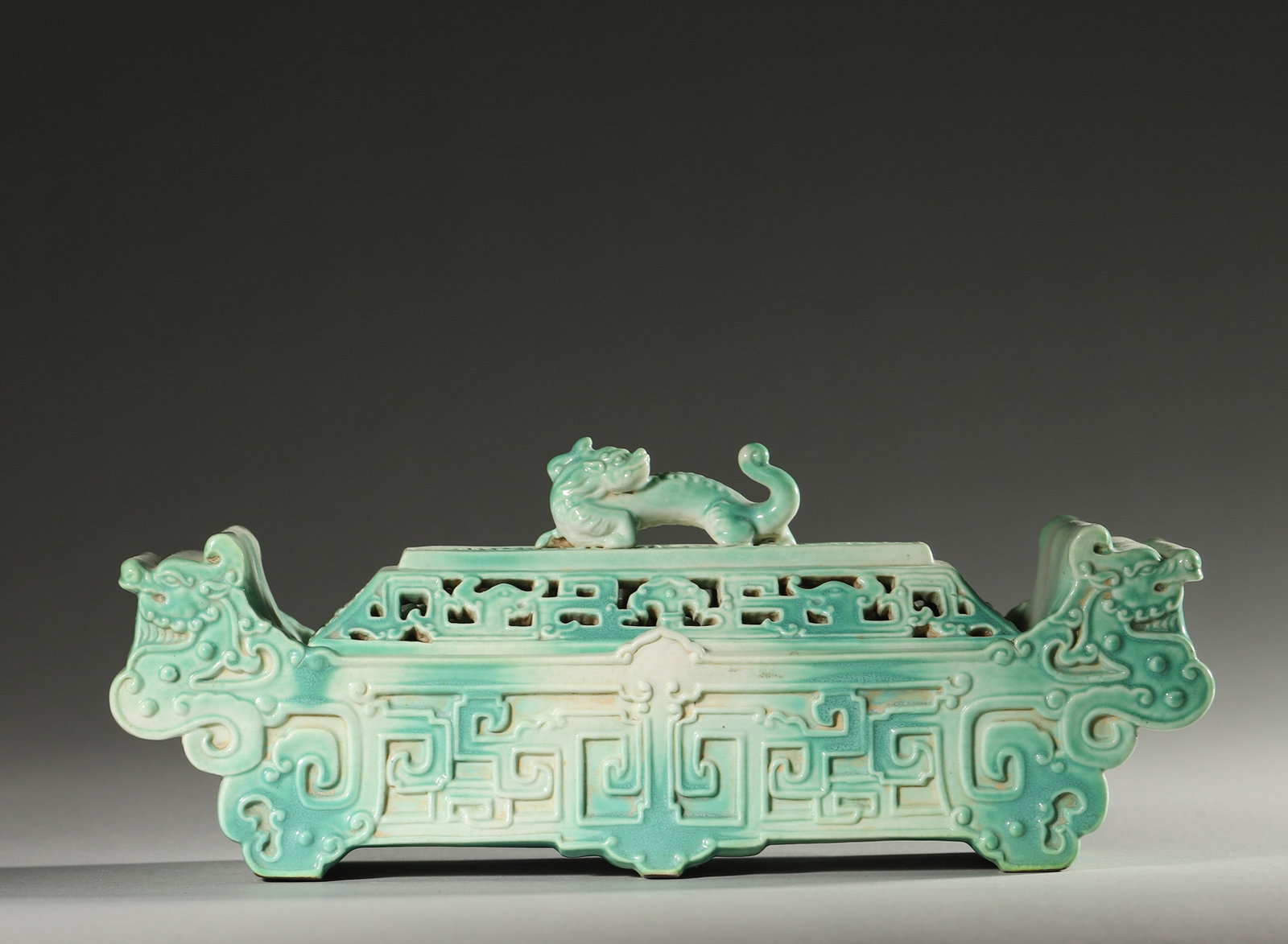 A 'DRAGON' PORCELAIN CENSER: A porcelain censer decorated with dragon motifs. L. 20 cm; W. 6 cm; Ht. 8 cm.