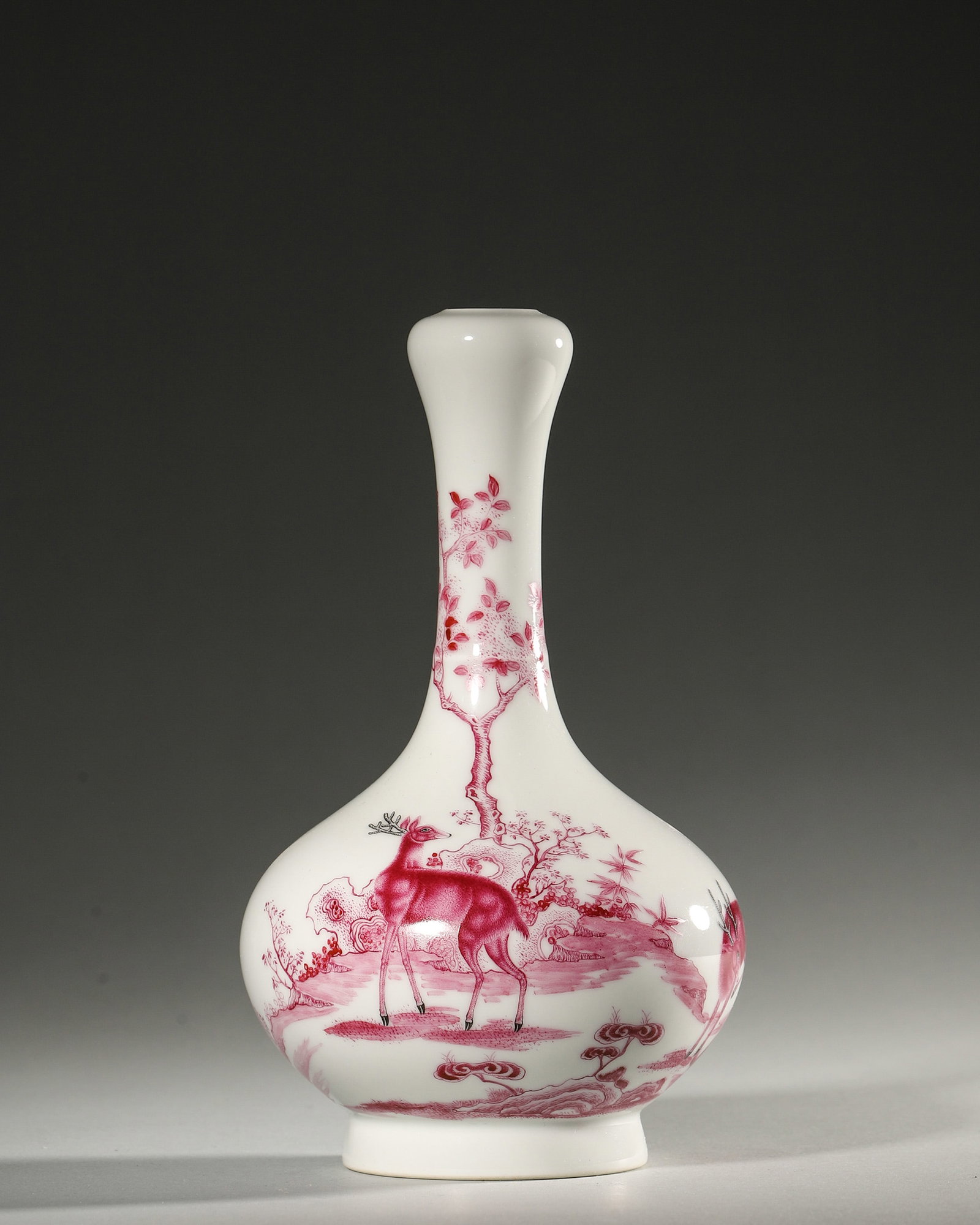 AN IRON-RED 'DEER' PORCELAIN VASE: A porcelain vase decorated in iron red with deer in a landscape. Diam. 12 cm; Ht. 19 cm.