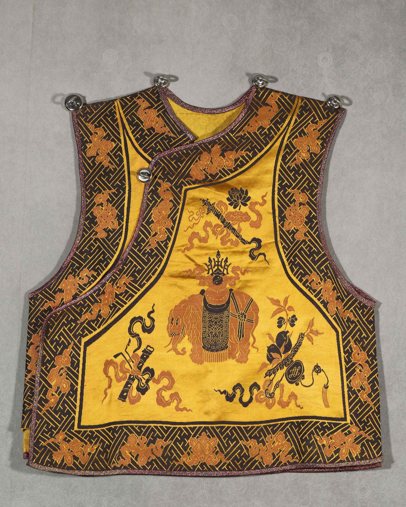 AN EMBROIDERED YELLOW VEST WITH ELEPHANT AND VASE MOTIFS: An embroidered yellow vest decorated with elephant and vase motifs. L. 61 cm; W. 58 cm.
