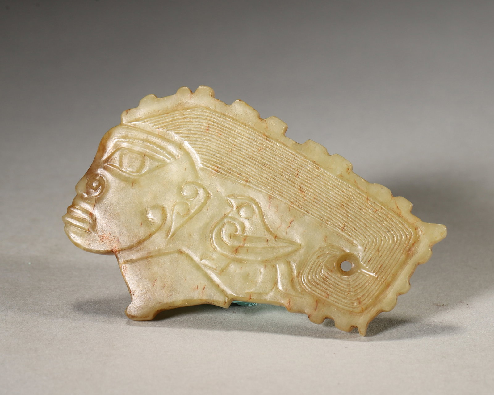 A JADE ORNAMENT WITH FACE AND BIRD MOTIFS (1 of 7)