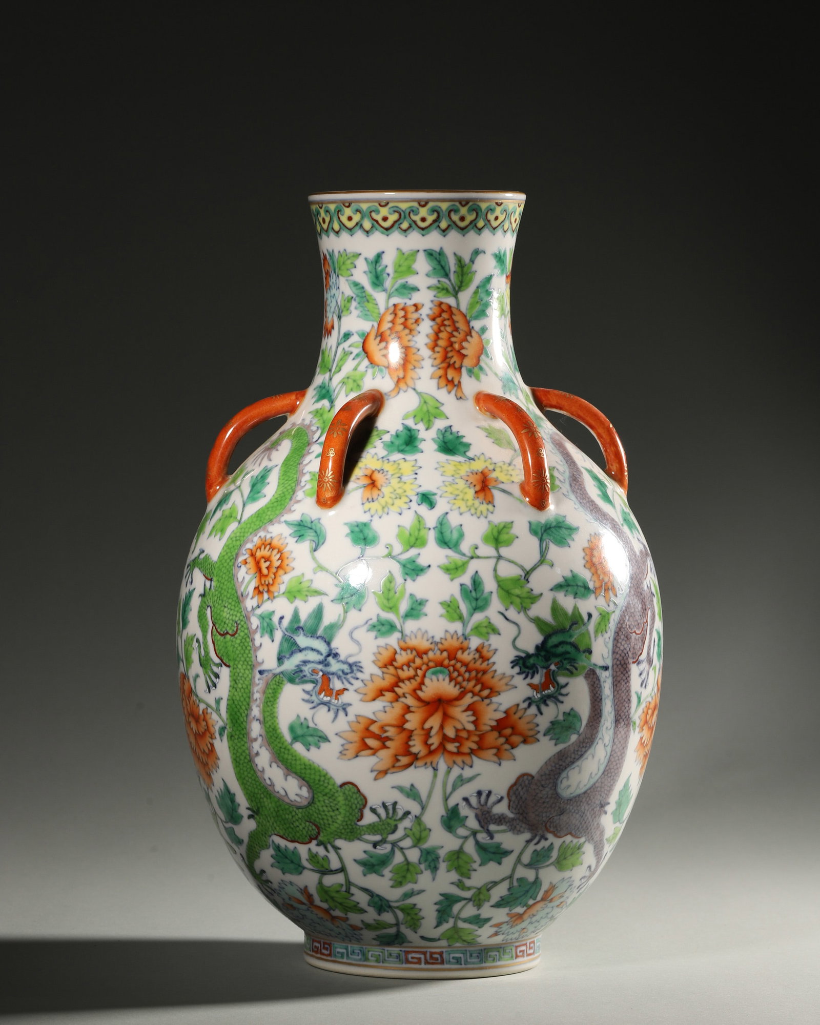 A FAMILLE-ROSE 'FLOWER AND DRAGON' PORCELAIN VASE: A famille-rose porcelain vase decorated with flowers and dragons. Diam. 18 cm; Ht. 22 cm.
