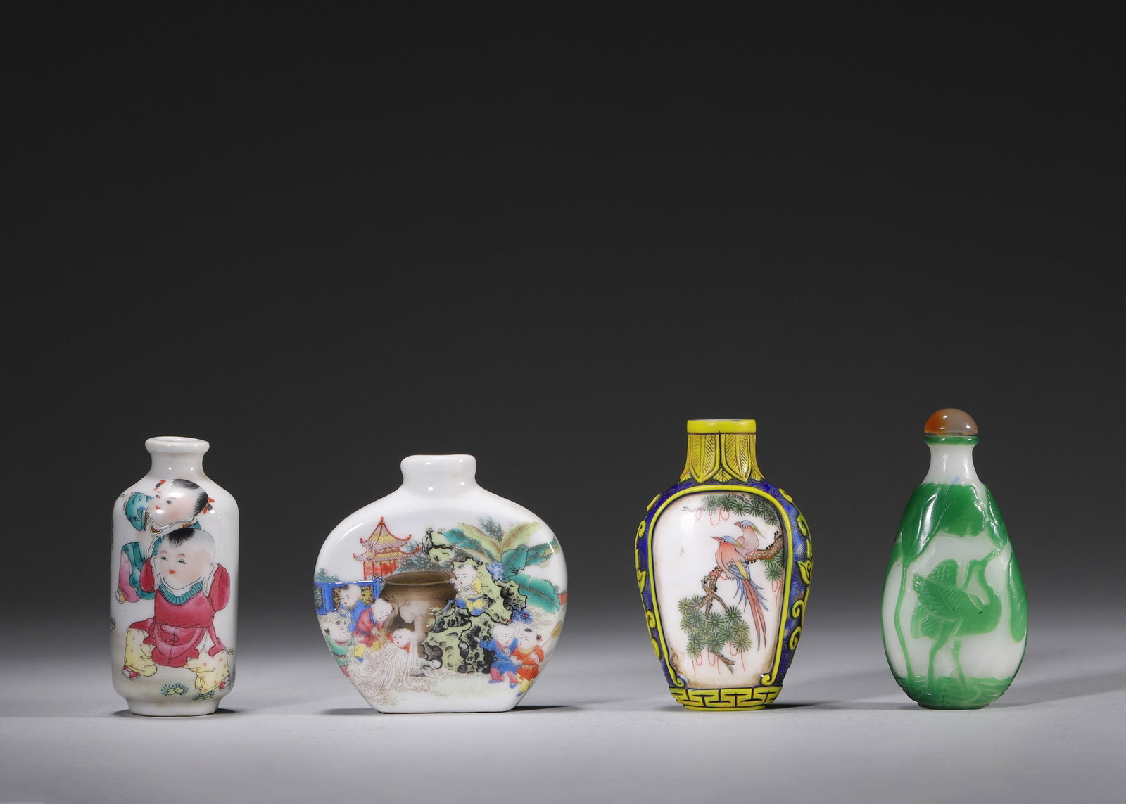 A SET OF FOUR PORCELAIN AND OVERLAY-GLASS SNUFF BOTTLES (1 of 10)