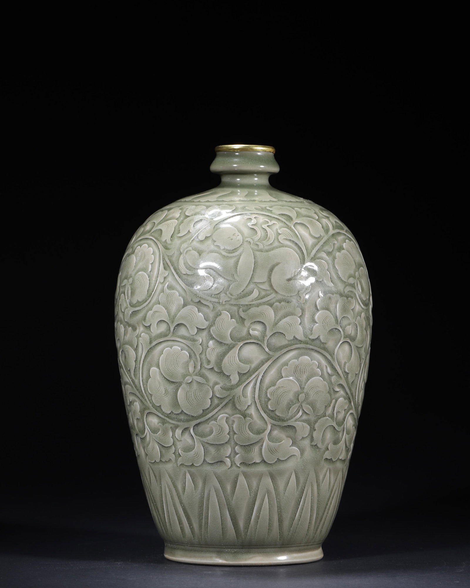 A YAOZHOU-TYPE CELADON-GLAZED CARVED 'BOYS AND FLORAL SCROLLS' MEIPING: A meiping-form porcelain vase covered in an olive-green celadon glaze and carved with boys amid floral scrolls, with a gilt-metal-mounted rim. Dimensions: 16 x 26 cm.