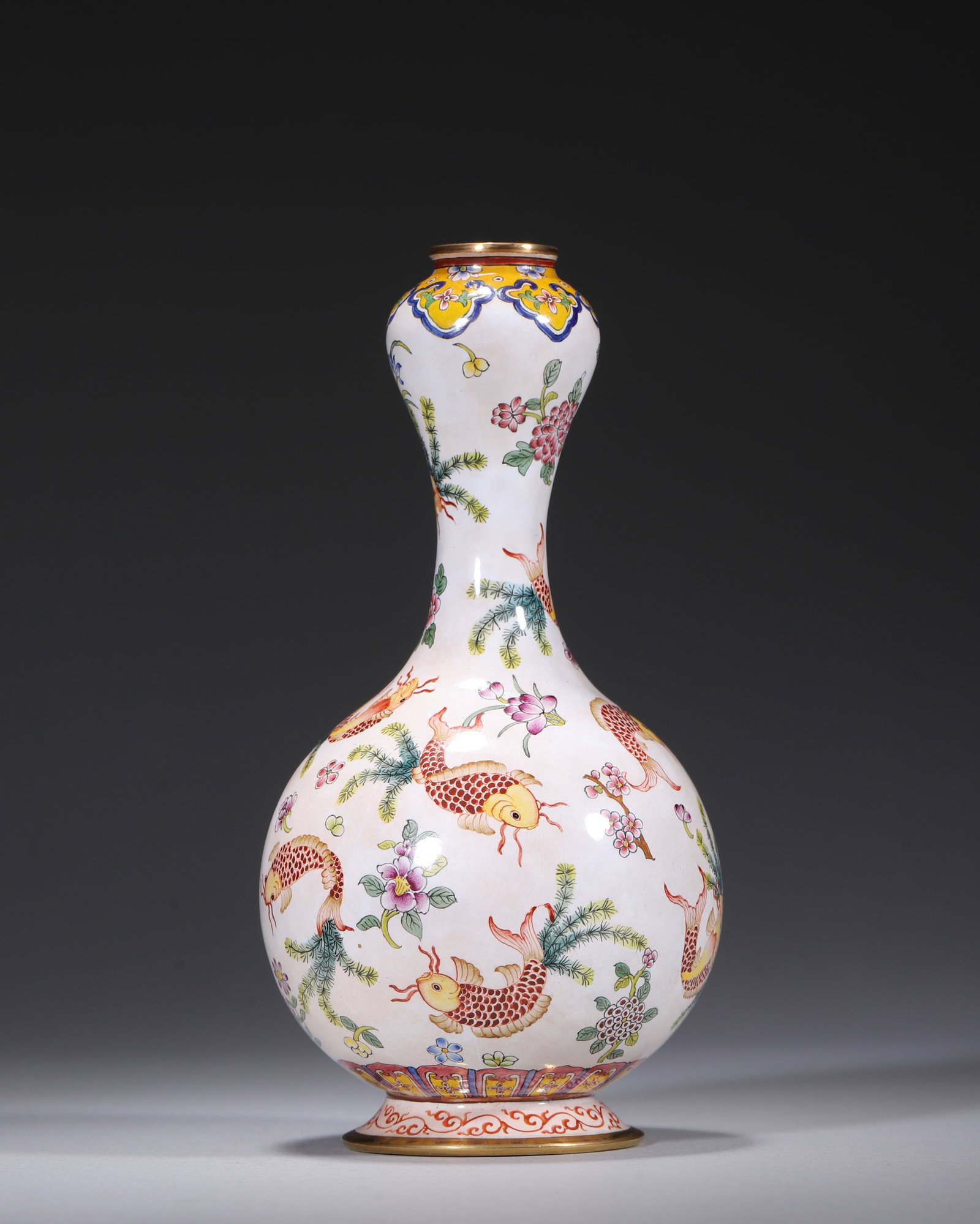 A PAINTED-ENAMEL BRONZE GARLIC-HEAD VASE WITH CARP AND FLOWERS: A painted-enamel bronze garlic-head vase with gilt rim and foot, decorated on a white ground with carp, aquatic plants and seasonal flowers. The base bears a mark described in the source as 'Qianlong