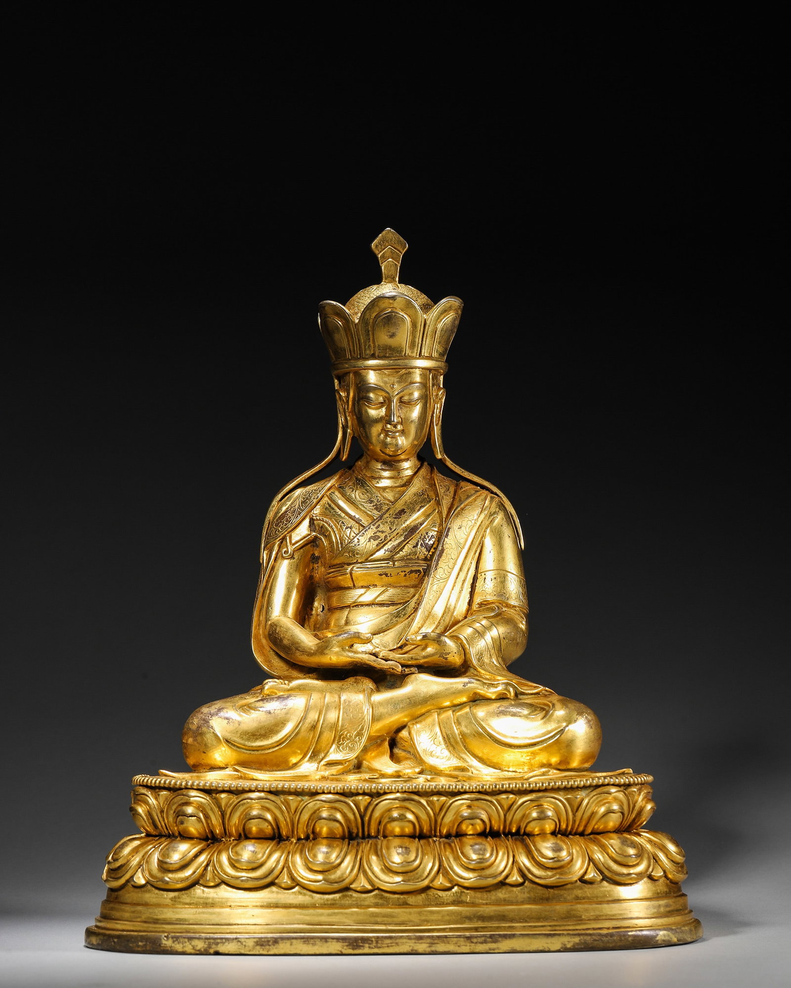 A GILT-BRONZE FIGURE OF KSITIGARBHA: A gilt-bronze figure of Ksitigarbha. W. 20 cm; Ht. 25 cm; Wt. 2,850 g.