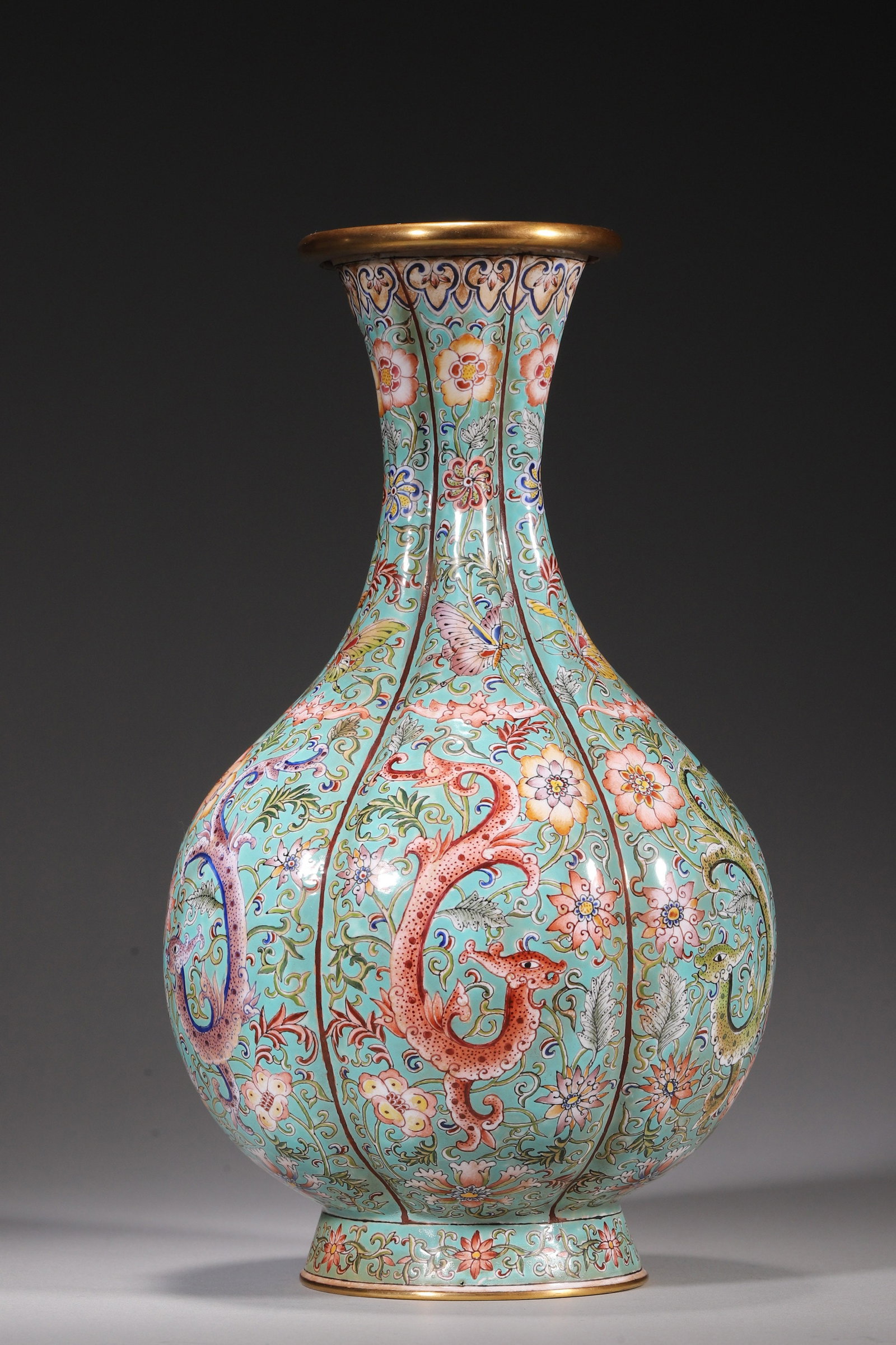 A COPPER-BODY PAINTED-ENAMEL TURQUOISE-GROUND MELON-RIBBED YUHUCHUN VASE: A copper-body painted-enamel yuhuchun vase of melon-ribbed form, with gilt rim and foot, decorated with kui dragons, floral scrolls and butterflies on a turquoise ground. The neck is decorated with se