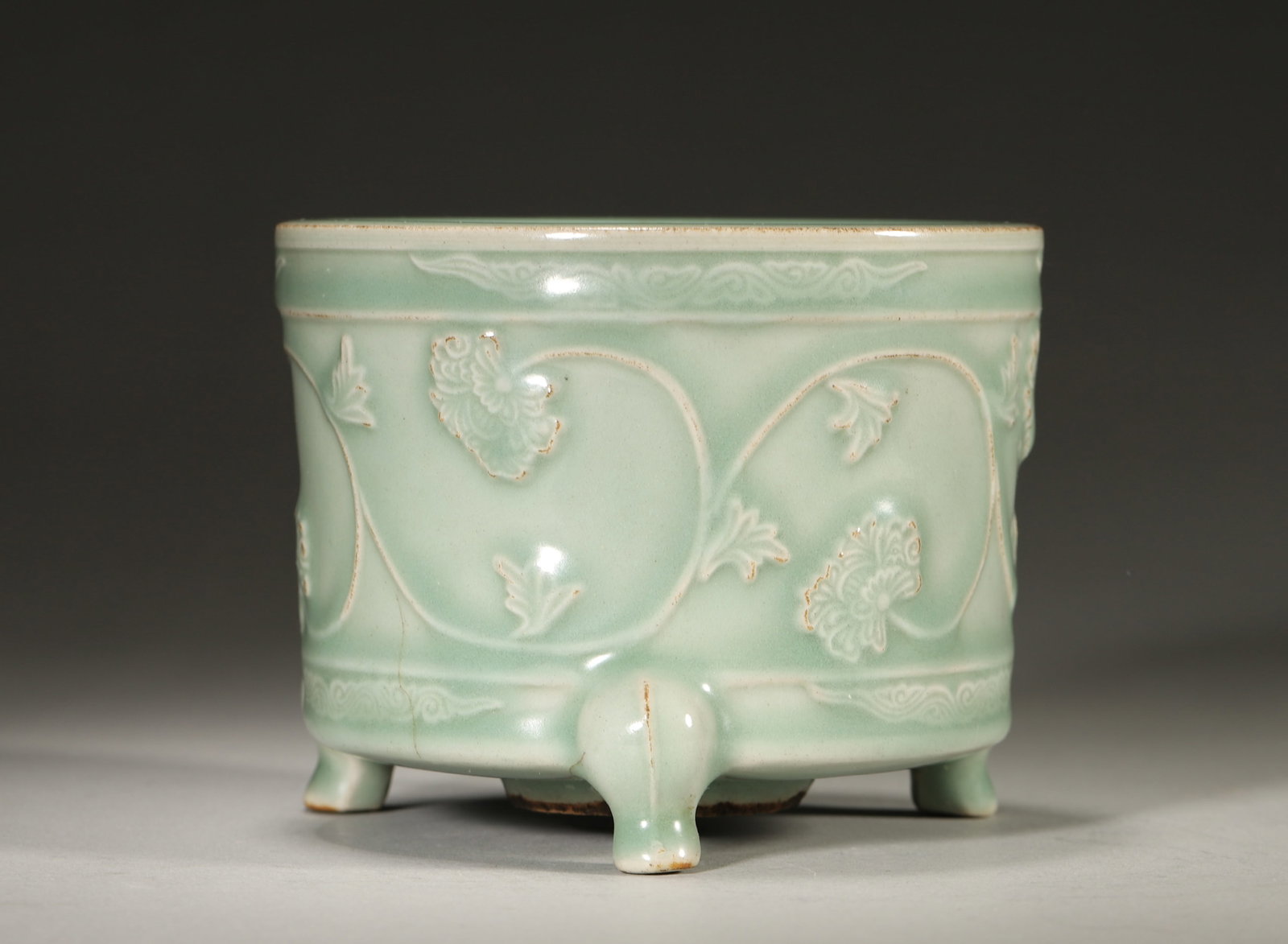 A LONGQUAN-TYPE CELADON MOLDED-FLORAL TRIPOD CENSER (1 of 5)