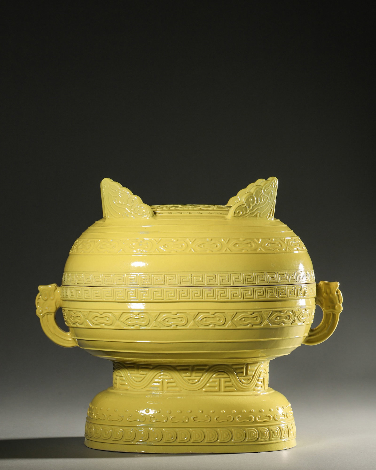 A YELLOW-GLAZED PORCELAIN CENSER: A yellow-glazed porcelain censer. L. 28 cm; Ht. 23 cm.