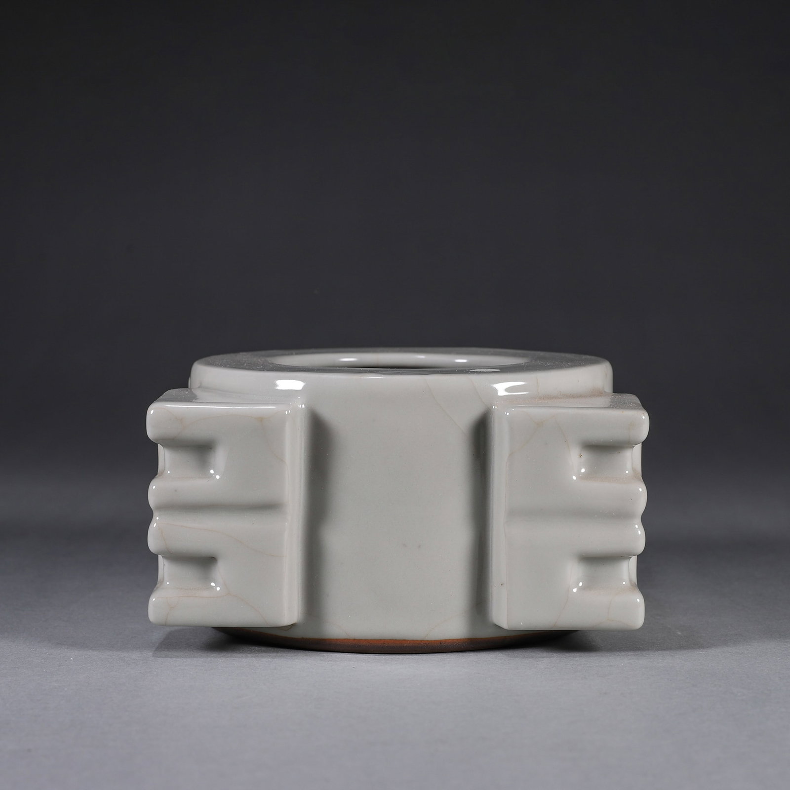 A GUAN-TYPE CRACKLE-GLAZED CONG-FORM WATER POT: A cong-form porcelain water pot with four flanges, covered in a Guan-type crackle glaze. L. 13 cm; W. 13 cm; Ht. 7.5 cm; Wt. 970 g.