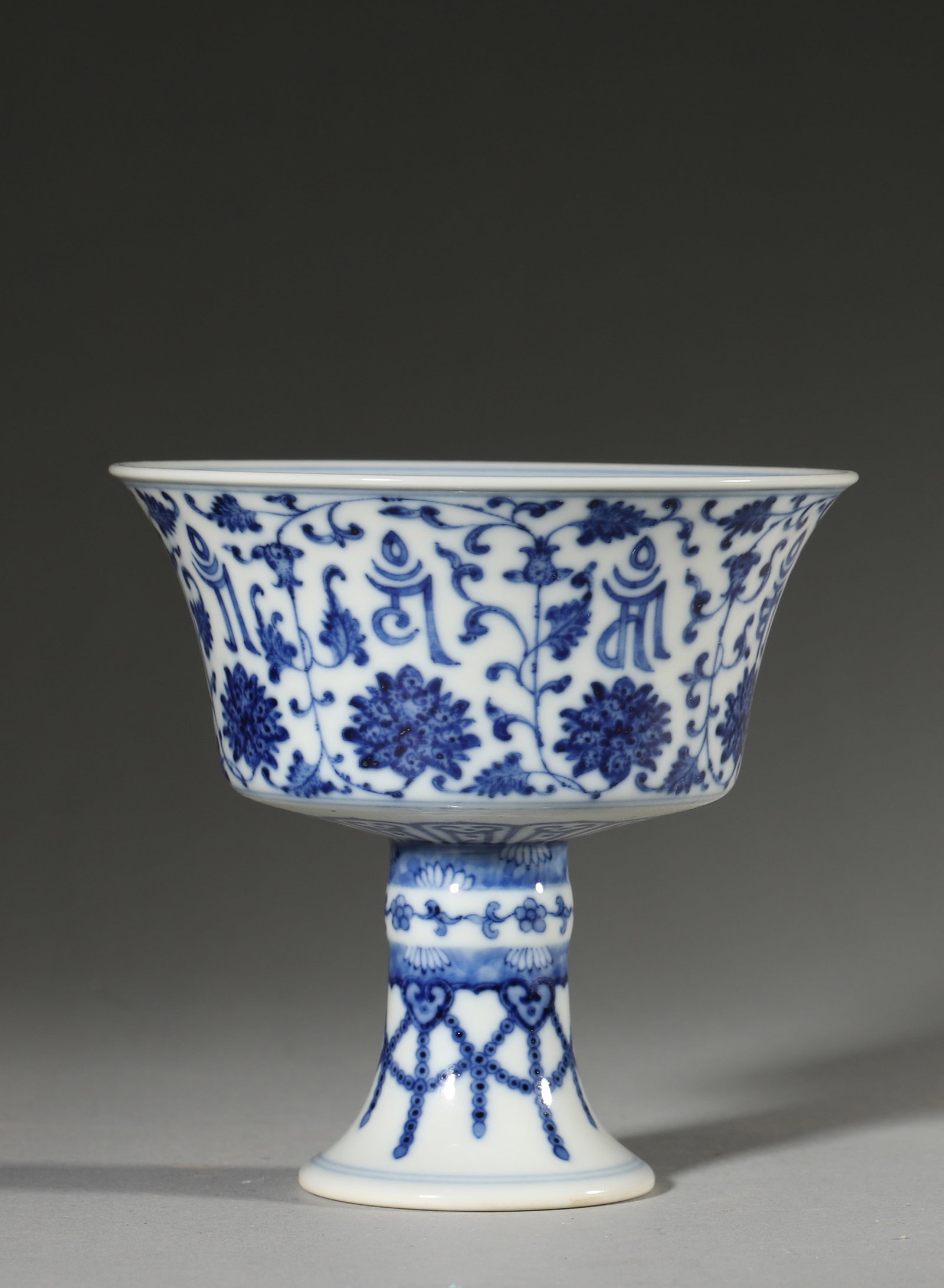 A BLUE-AND-WHITE 'LOTUS AND SANSKRIT' STEM CUP (1 of 7)