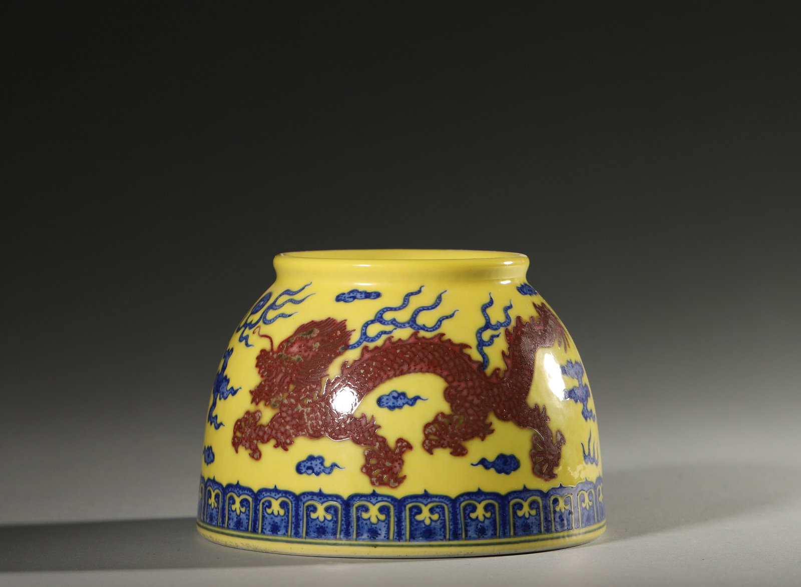 A YELLOW-GROUND UNDERGLAZE-RED 'DRAGON' PORCELAIN WATER POT: A porcelain water pot with a yellow ground, decorated in underglaze red with a dragon. Diam. 11 cm; Ht. 7.5 cm.