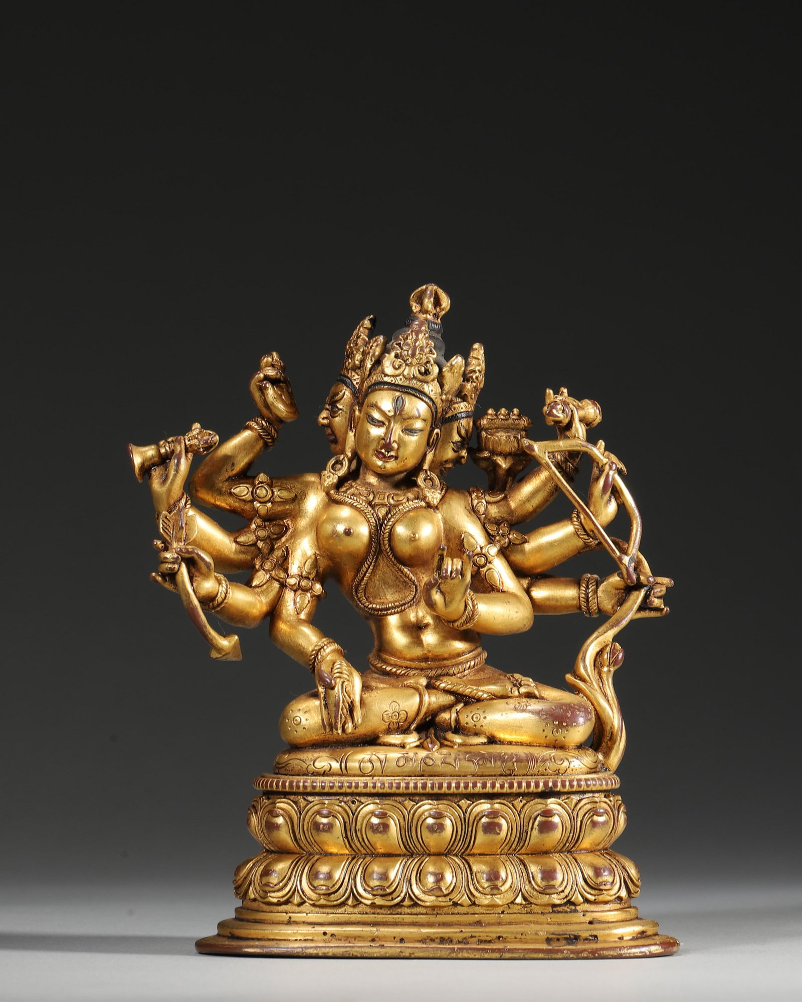 A GILT-COPPER-ALLOY FIGURE OF AN EIGHT-ARMED BUDDHIST DEITY (1 of 9)