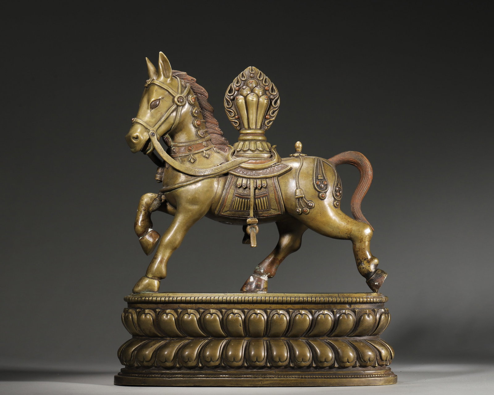 A COPPER FIGURE OF A WIND HORSE WITH COLORED-STONE INLAY: A copper figure of a Wind Horse carrying a wish-fulfilling jewel, set with colored stones and standing on a double-lotus base, with a sealed base. Dimensions: 24 x 10 x 29 cm; Wt. 4,314 g.
