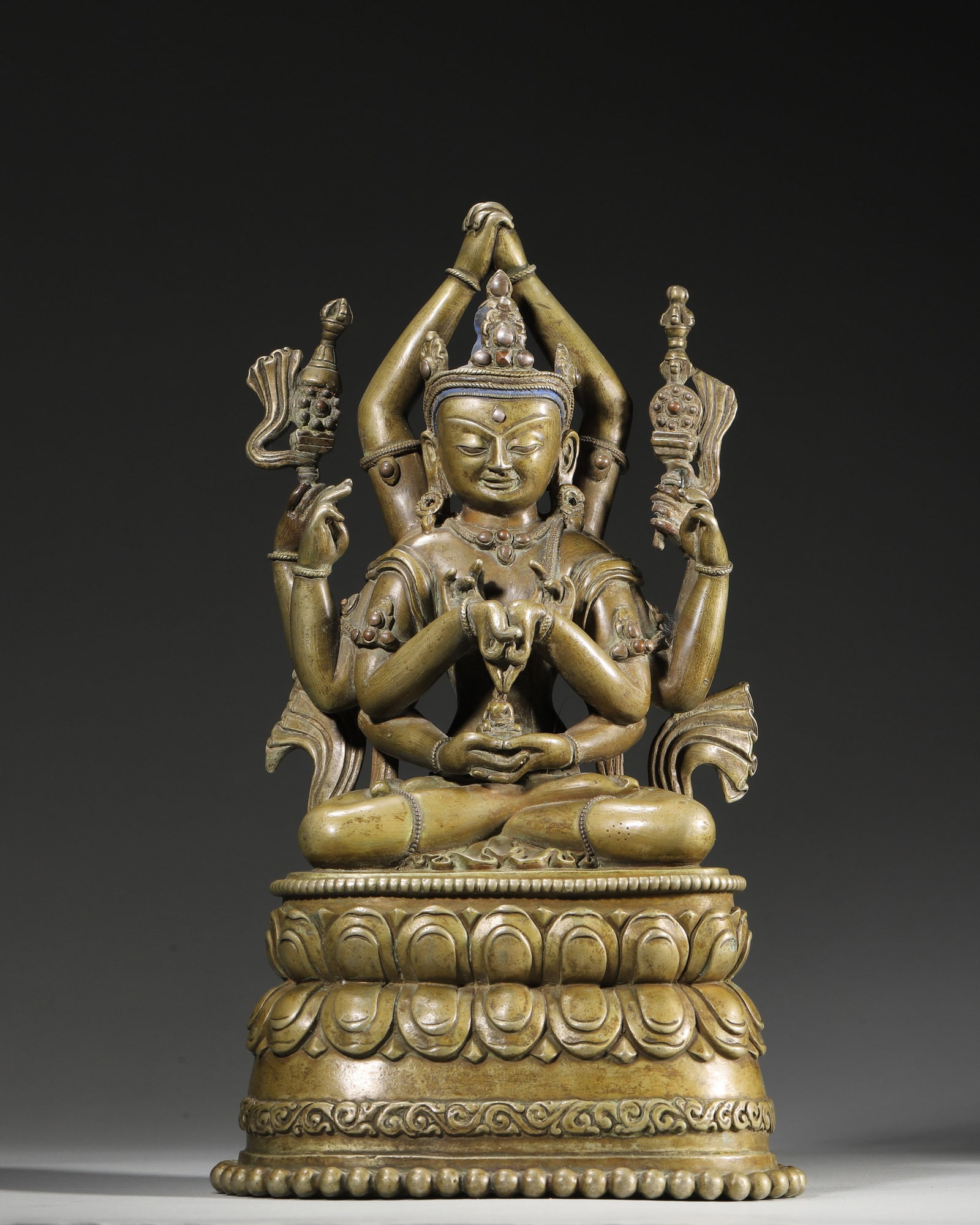 A GILT-COPPER-ALLOY FIGURE OF A SIX-ARMED BUDDHIST DEITY (1 of 9)