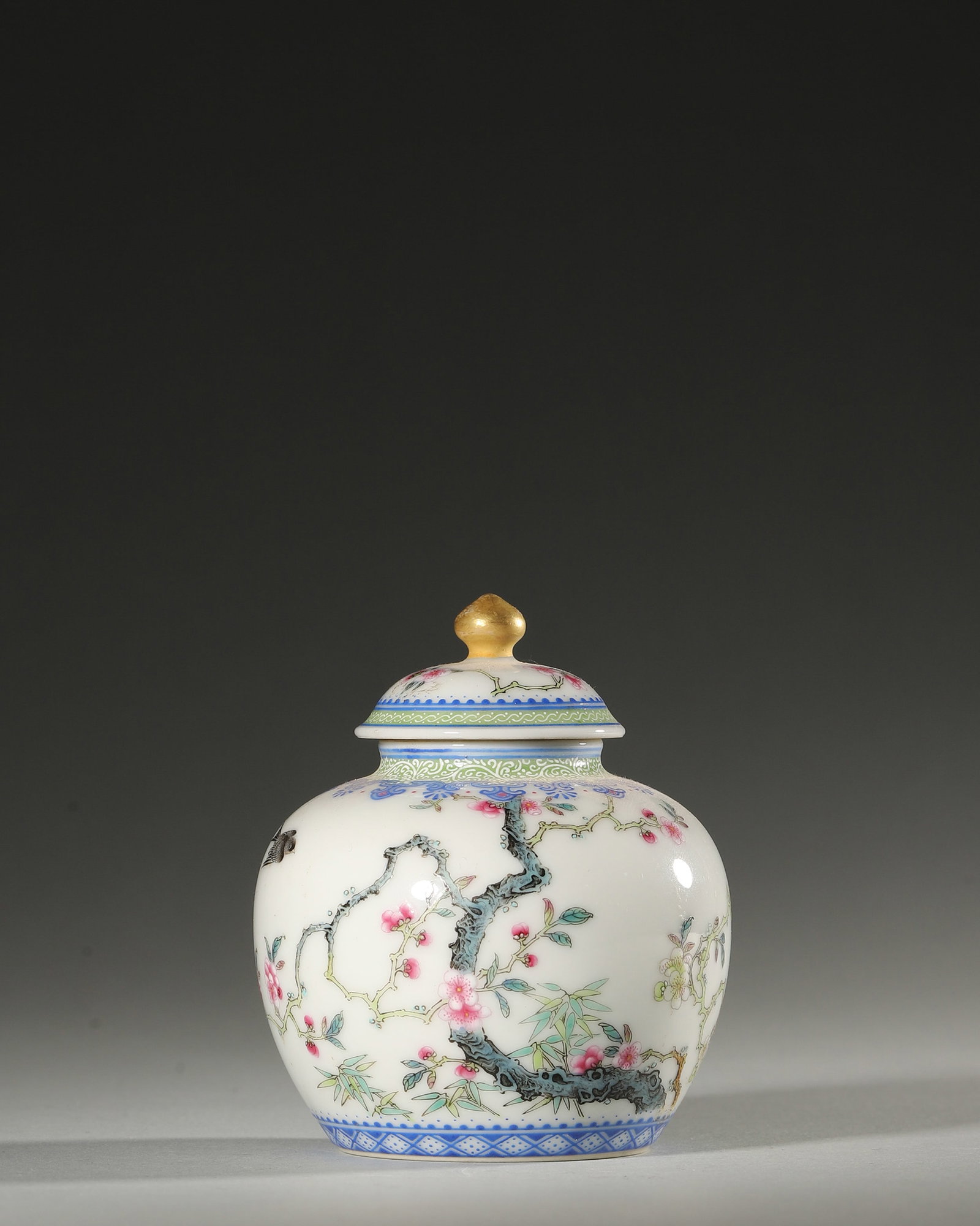 A FAMILLE-ROSE 'FLOWER AND BIRD' PORCELAIN JAR: A famille-rose porcelain jar decorated with flowers and birds. Diam. 7.5 cm; Ht. 8 cm.